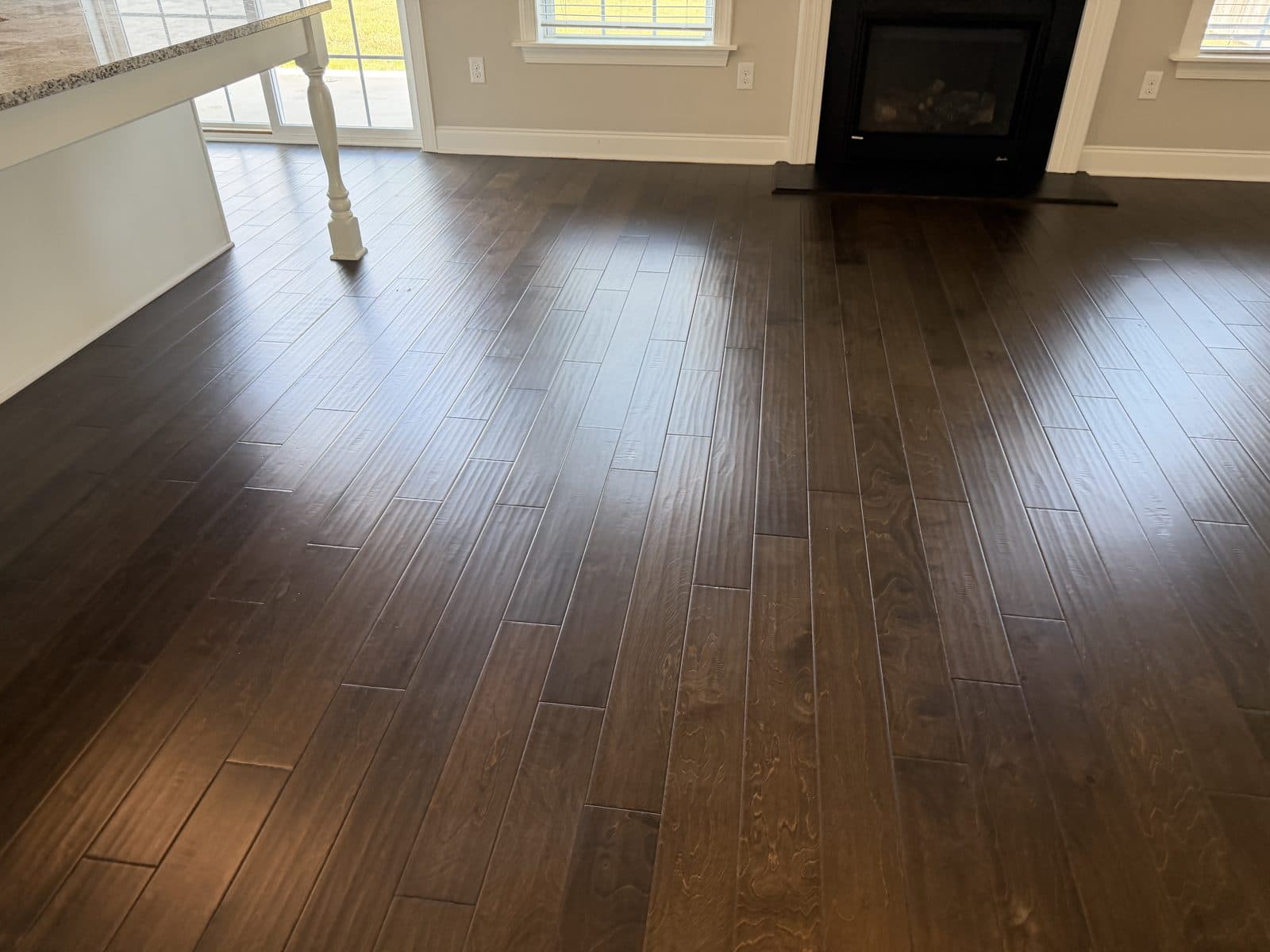 Hand-scraped engineered hardwood floor in Fuquay-Varina NC after polish removal and deep cleaning, grain and texture visible under an even sheen