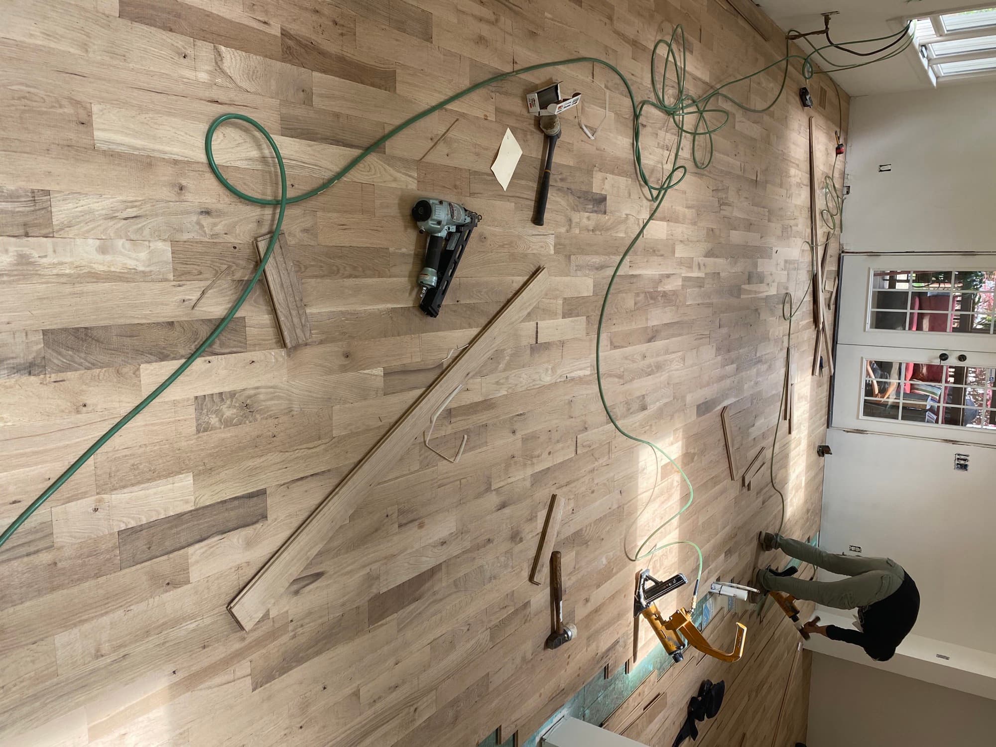 Nail-down installation of 2-1/4 inch white oak strip flooring in progress in a Triangle NC living room