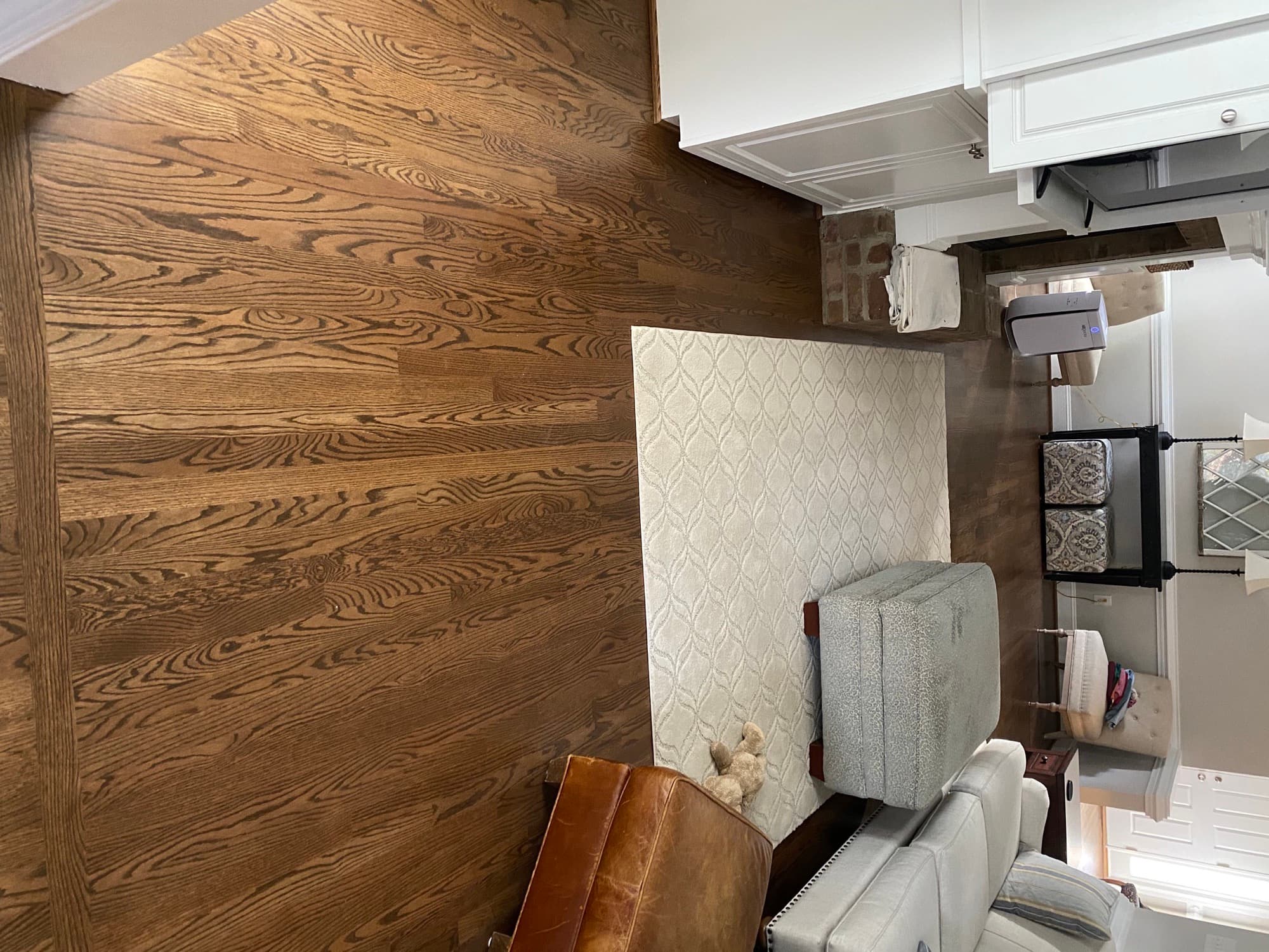 Refinished red oak living room floor in a Triangle NC home with a medium brown stain, showing the pronounced open grain pattern of red oak