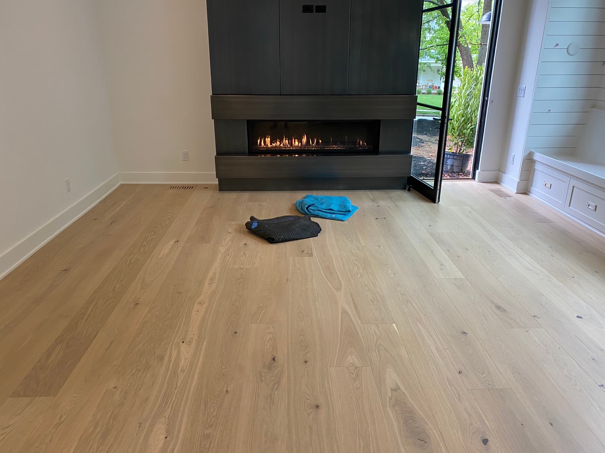 Wide plank European white oak floor finished in Bona Traffic HD in a modern living room with a linear fireplace