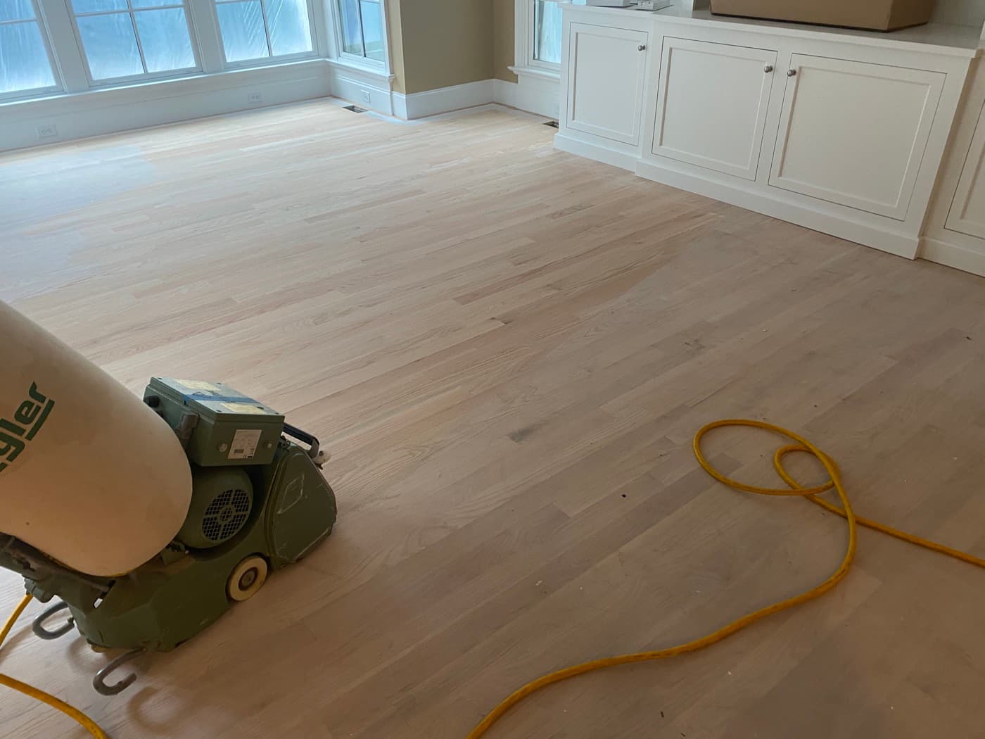 Lagler Hummel belt sander on 3.25-inch red oak hardwood floor sanded bare in Raleigh NC
