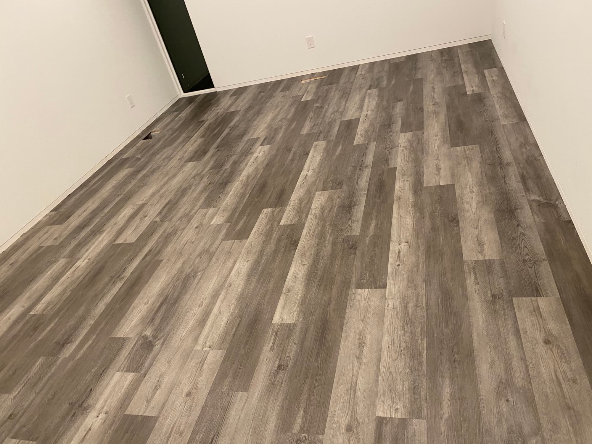 Laminate flooring installation in progress over underlayment by 12th And Oak Floor Co. Clayton NC