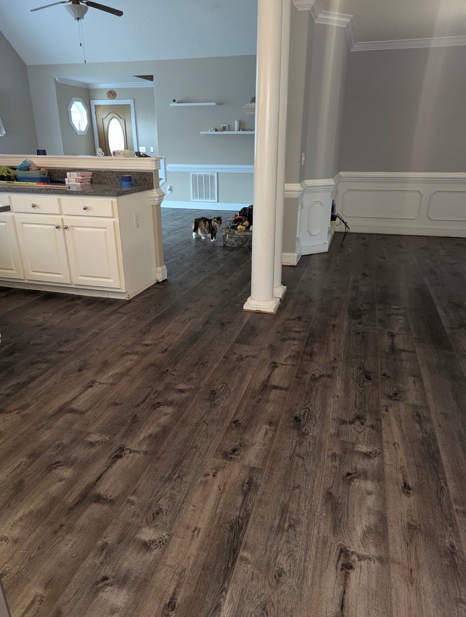 Completed luxury vinyl plank flooring installation in open concept kitchen and living area in Clayton NC
