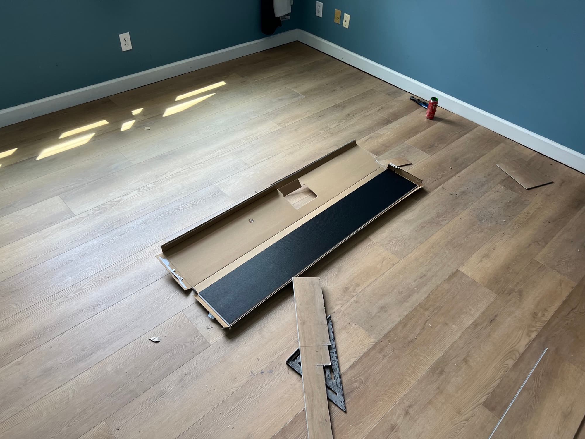 Wide plank LVP flooring installation in progress showing layout and transition planning by 12th And Oak Floor Co.