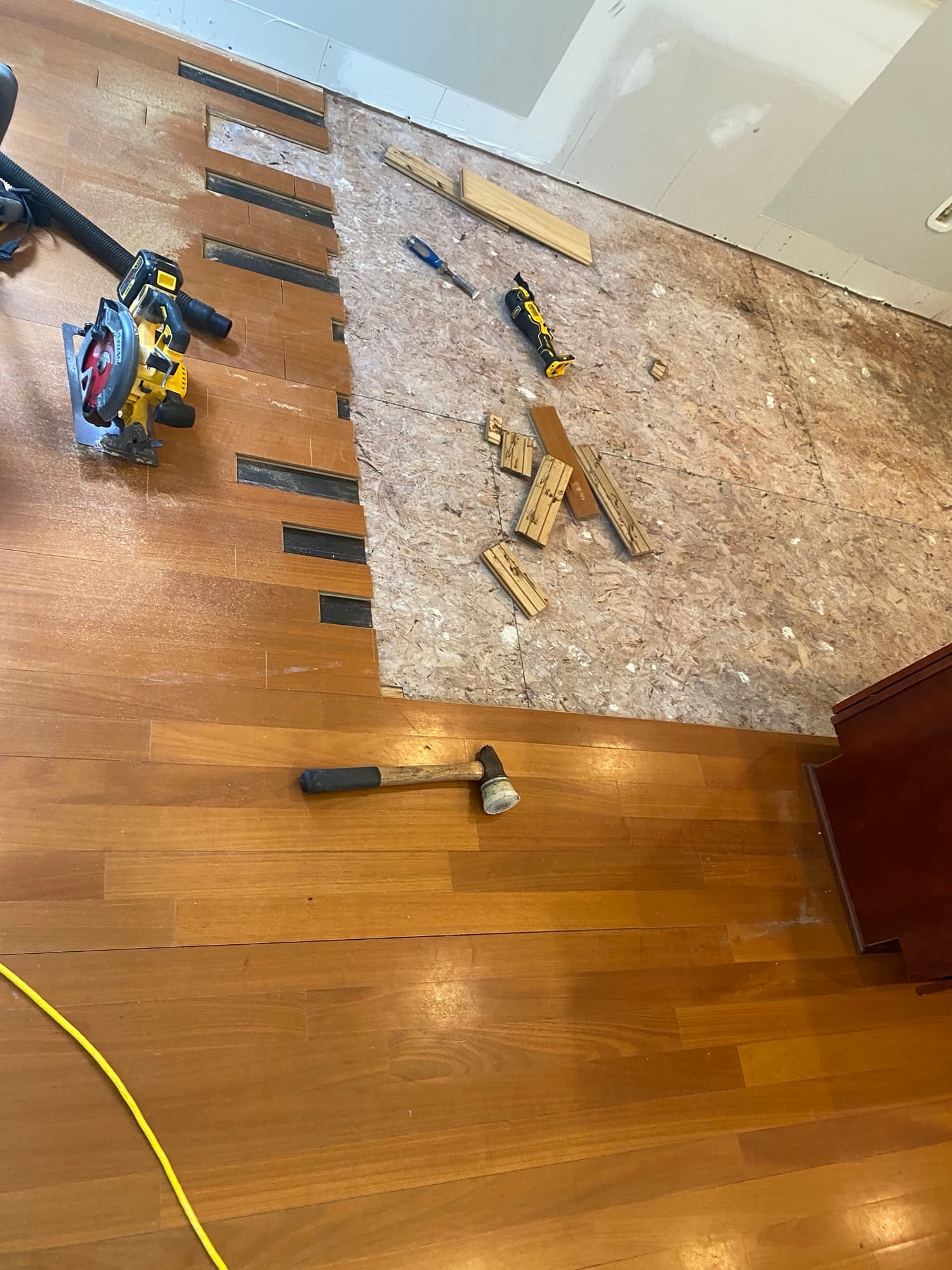 Water-damaged Brazilian oak flooring in kitchen area of McGregor Downs home in Cary NC, flooring removed to expose subfloor after leak