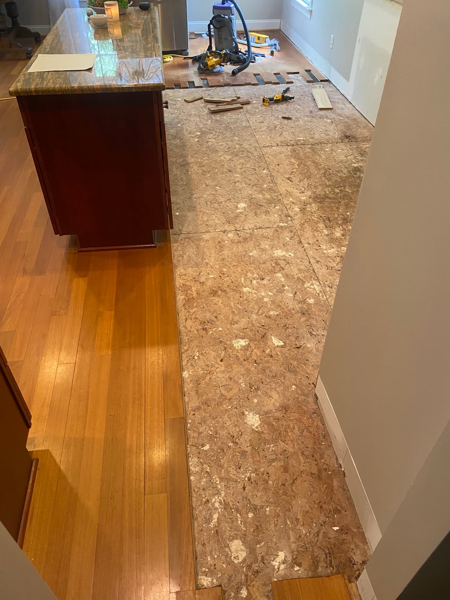 Close-up of water damage repair area in 3 1/8 inch Brazilian oak floor in Cary NC kitchen
