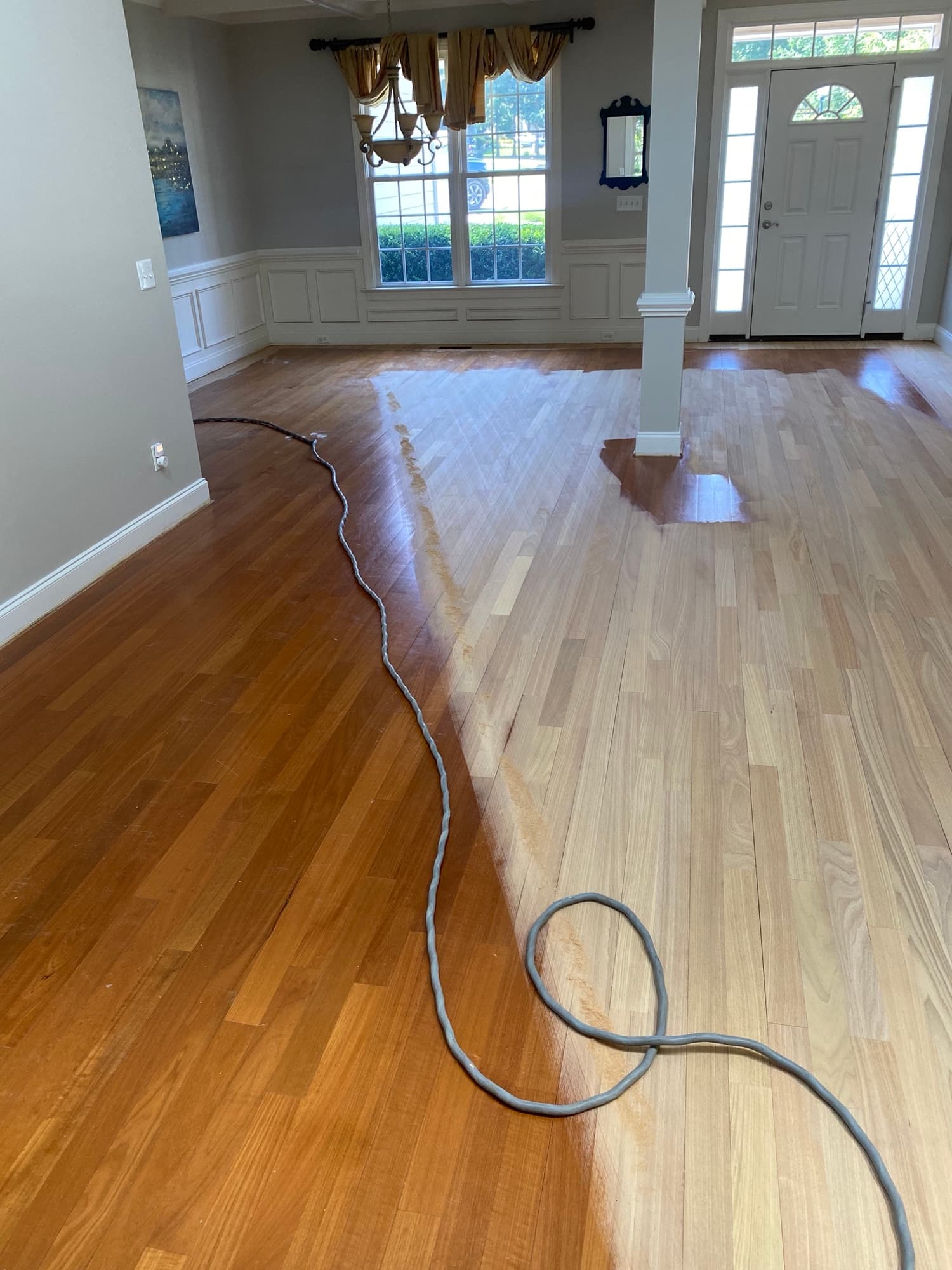 Big machine sanding Brazilian oak floor during water damage repair in McGregor Downs Cary NC