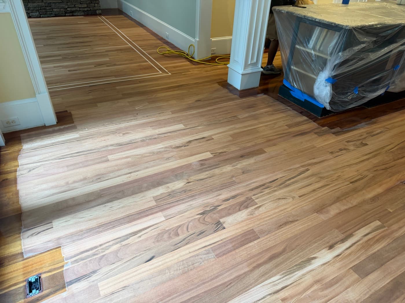Family room sanded to bare Brazilian Tigerwood during refinishing in Glen Laurel Clayton NC