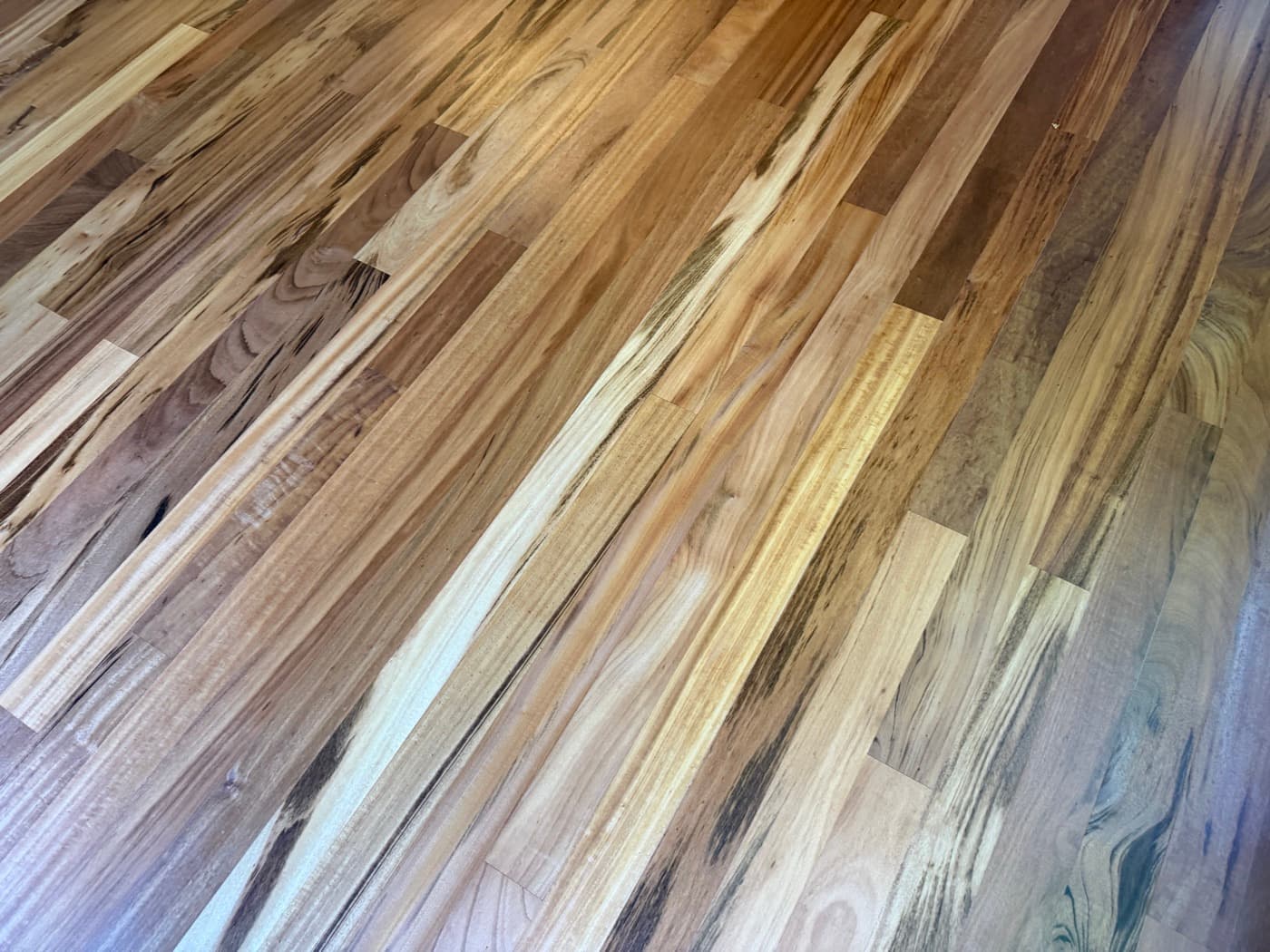 Raw sanded Brazilian tigerwood grain close-up during hardwood floor refinishing in Clayton NC, one of the hardest species on the Janka scale
