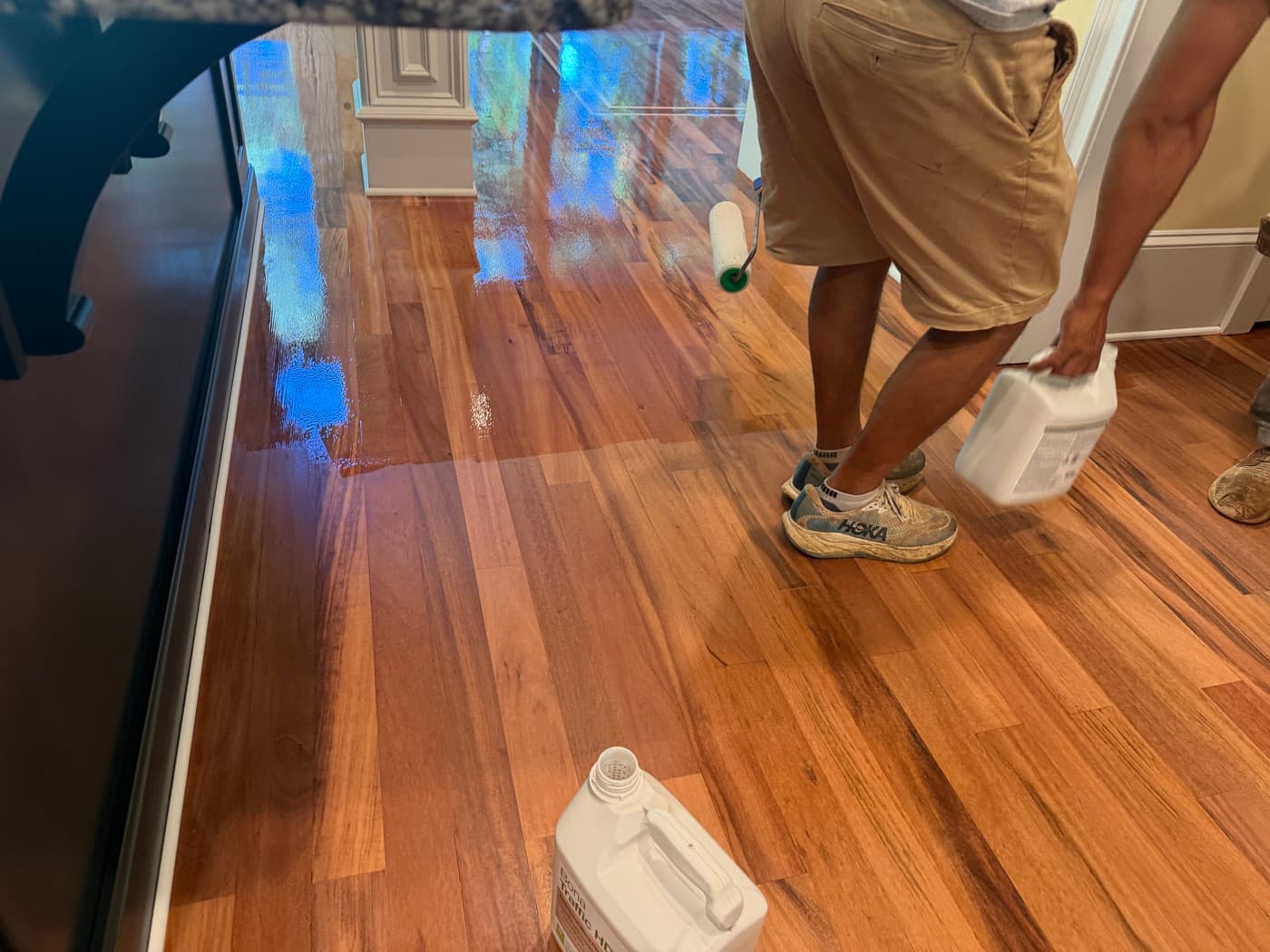Bona Traffic HD finish being applied to Brazilian Tigerwood floor, wet edge visible, in Glen Laurel Clayton NC