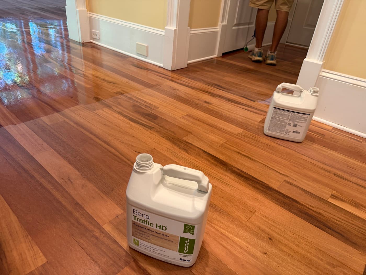Bona Traffic HD jugs staged on sealed Brazilian Tigerwood floor during coating in Clayton NC