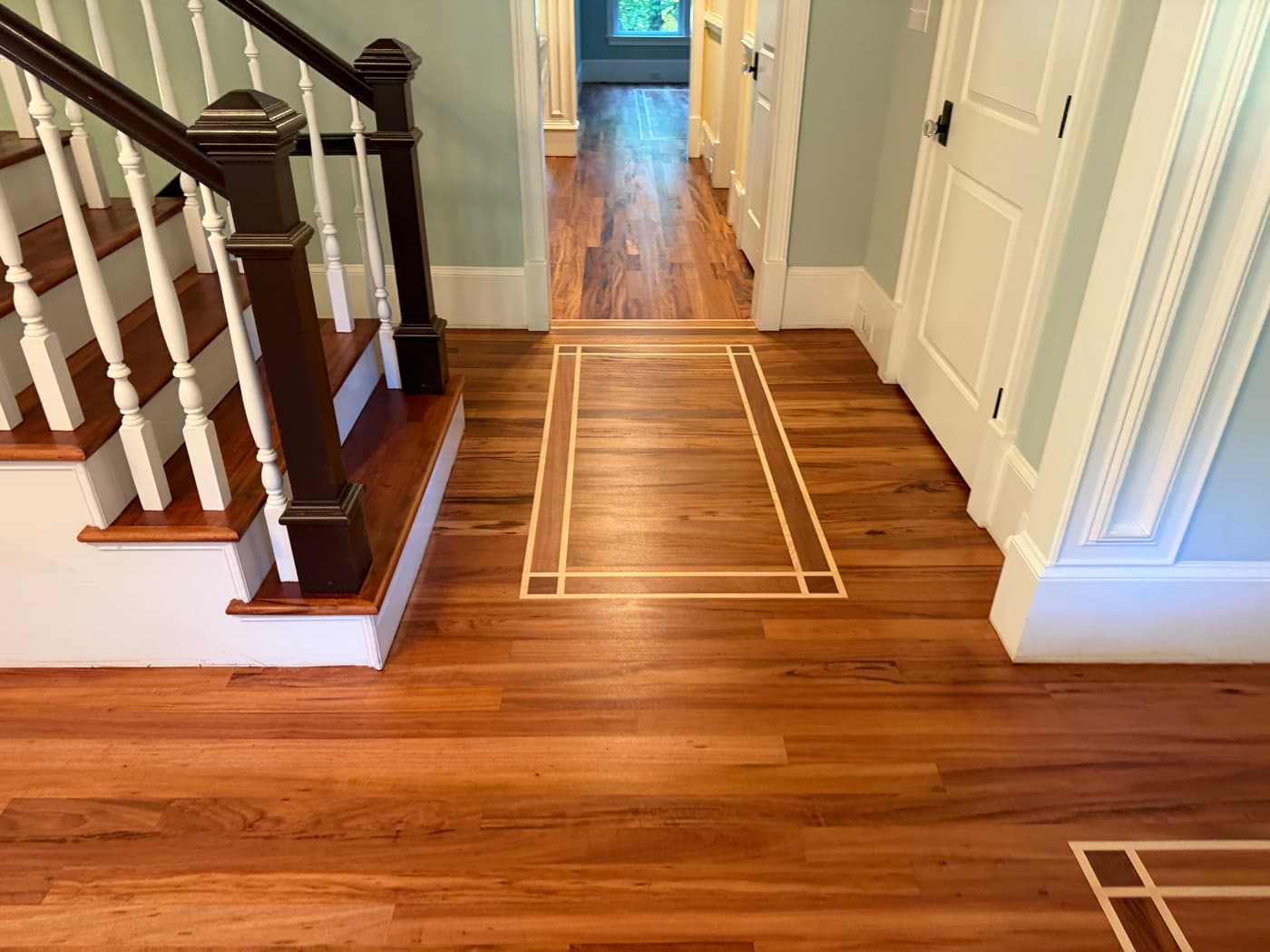Refinished Brazilian Tigerwood floor with maple inlay border and staircase, natural Bona Traffic HD finish, Glen Laurel Clayton NC