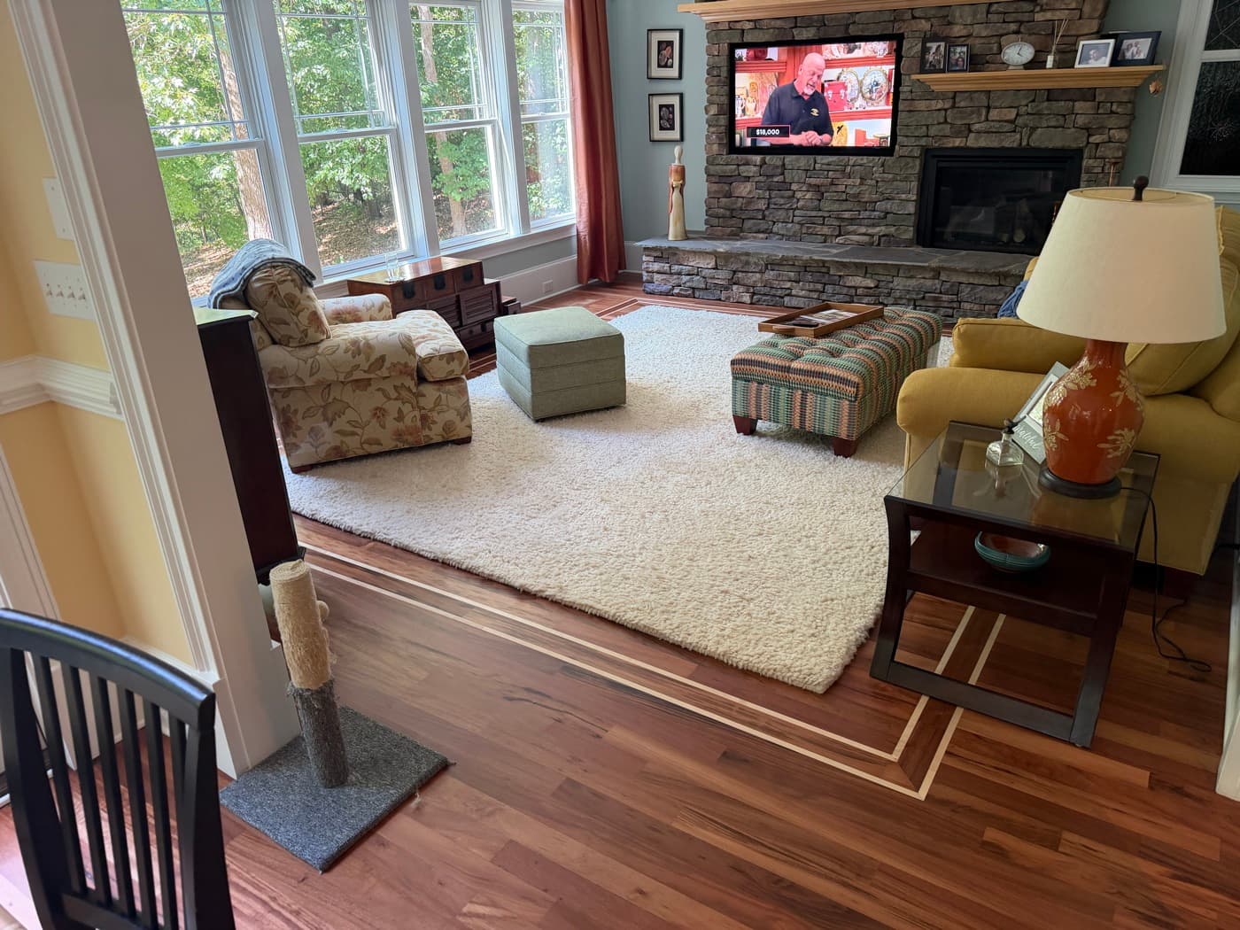 Furnished living room with refinished Brazilian Tigerwood floor and stone fireplace in Glen Laurel Clayton NC