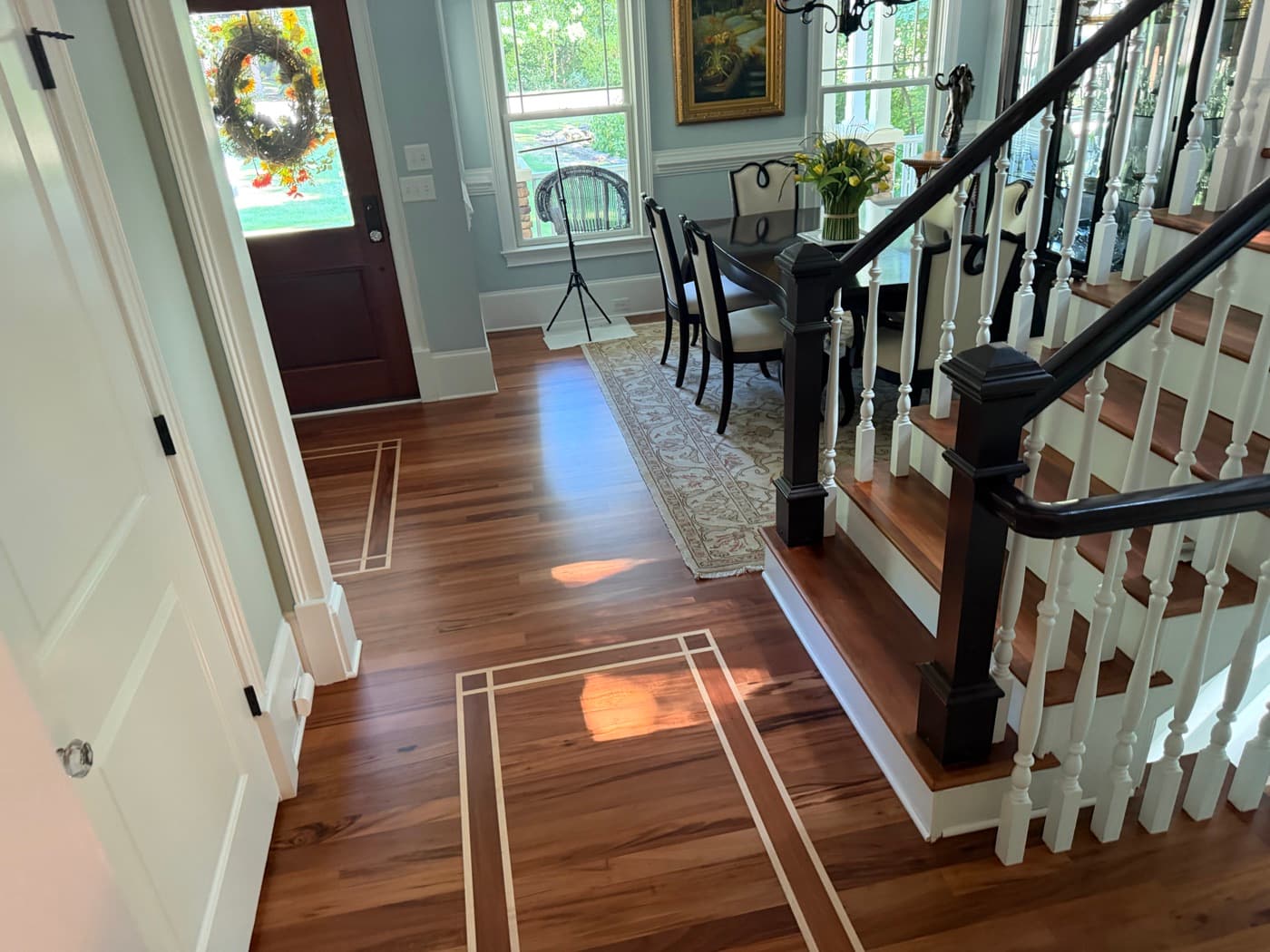 Furnished foyer with refinished Brazilian Tigerwood floor, maple inlay, and staircase in Glen Laurel Clayton NC