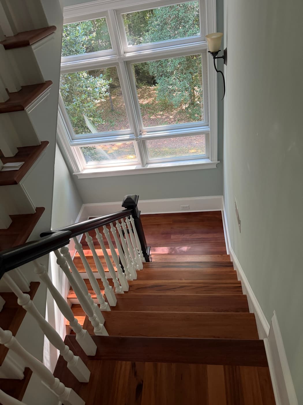 Refinished Brazilian Tigerwood staircase landing with large window in Glen Laurel Clayton NC