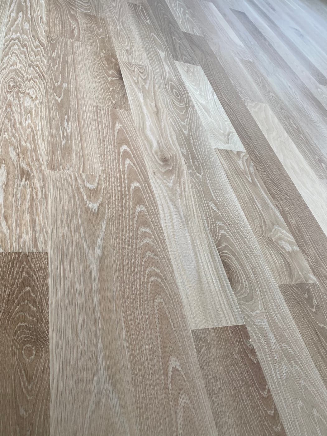 Close-up of sanded 5" engineered white oak showing open grain ready for stain