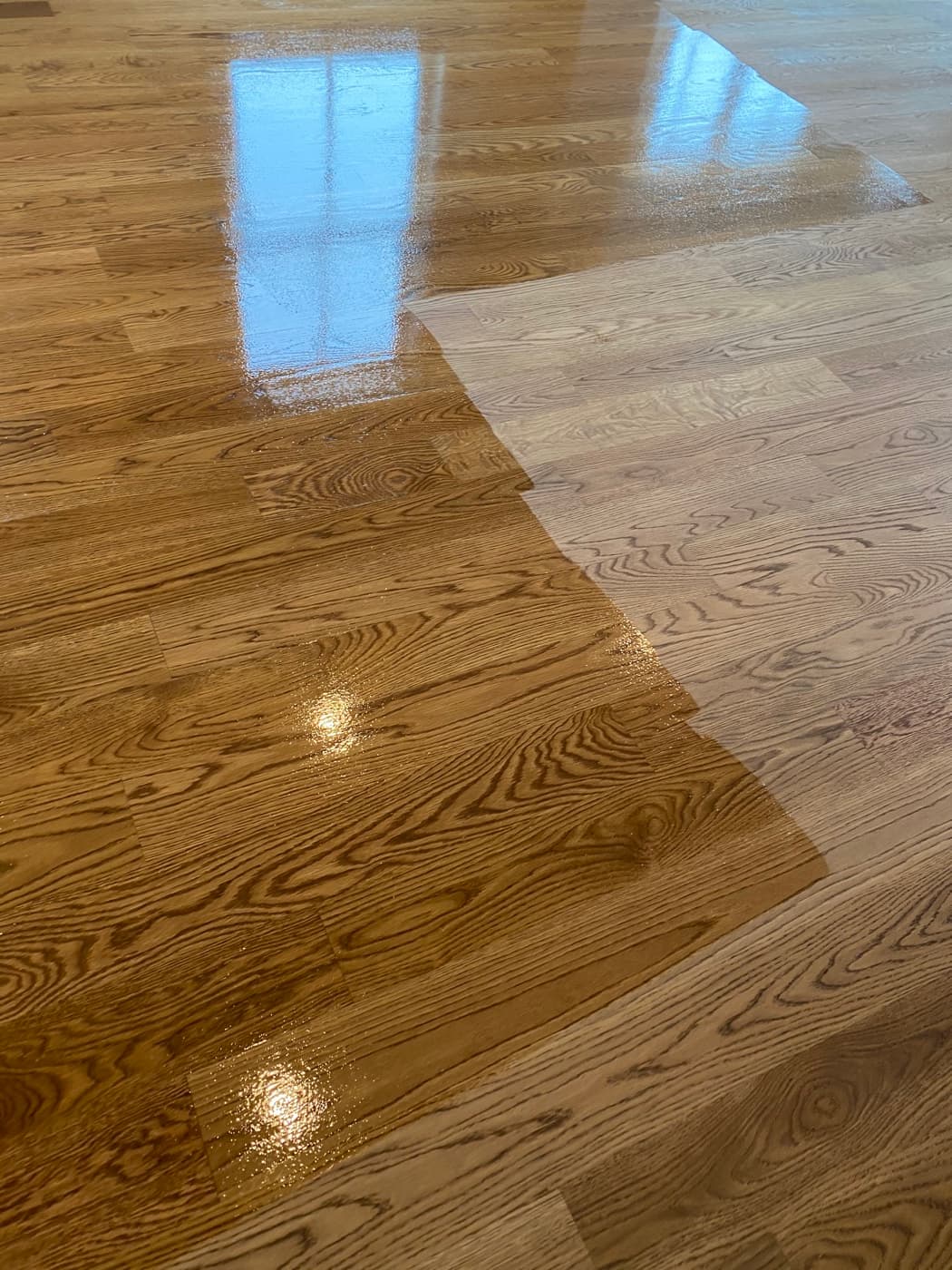 Bona Traffic HD finish coat being applied to white oak floor, wet sheen visible at leading edge