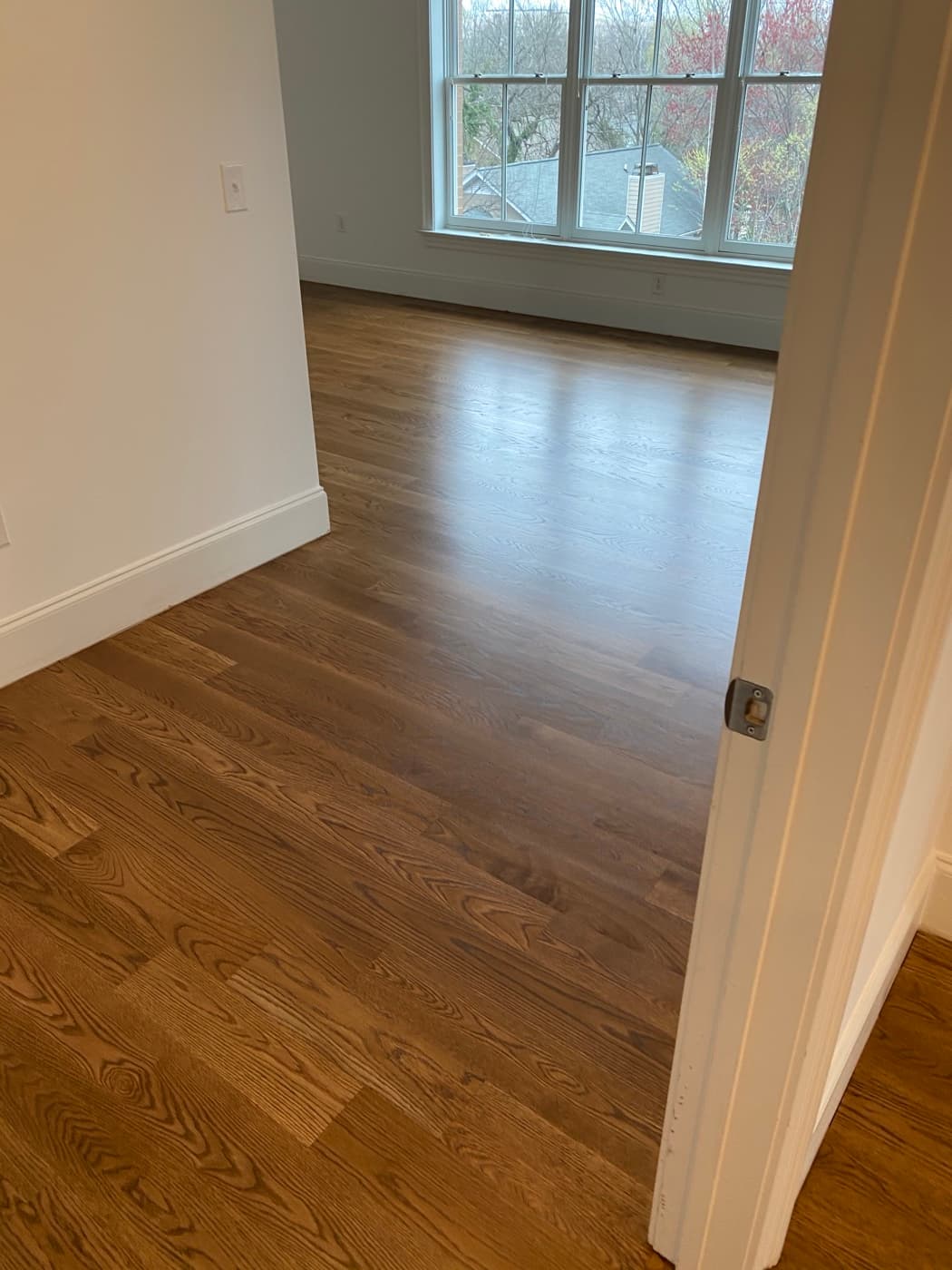 Finished white oak bedroom floor with DuraSeal Special Walnut stain, viewed through doorway