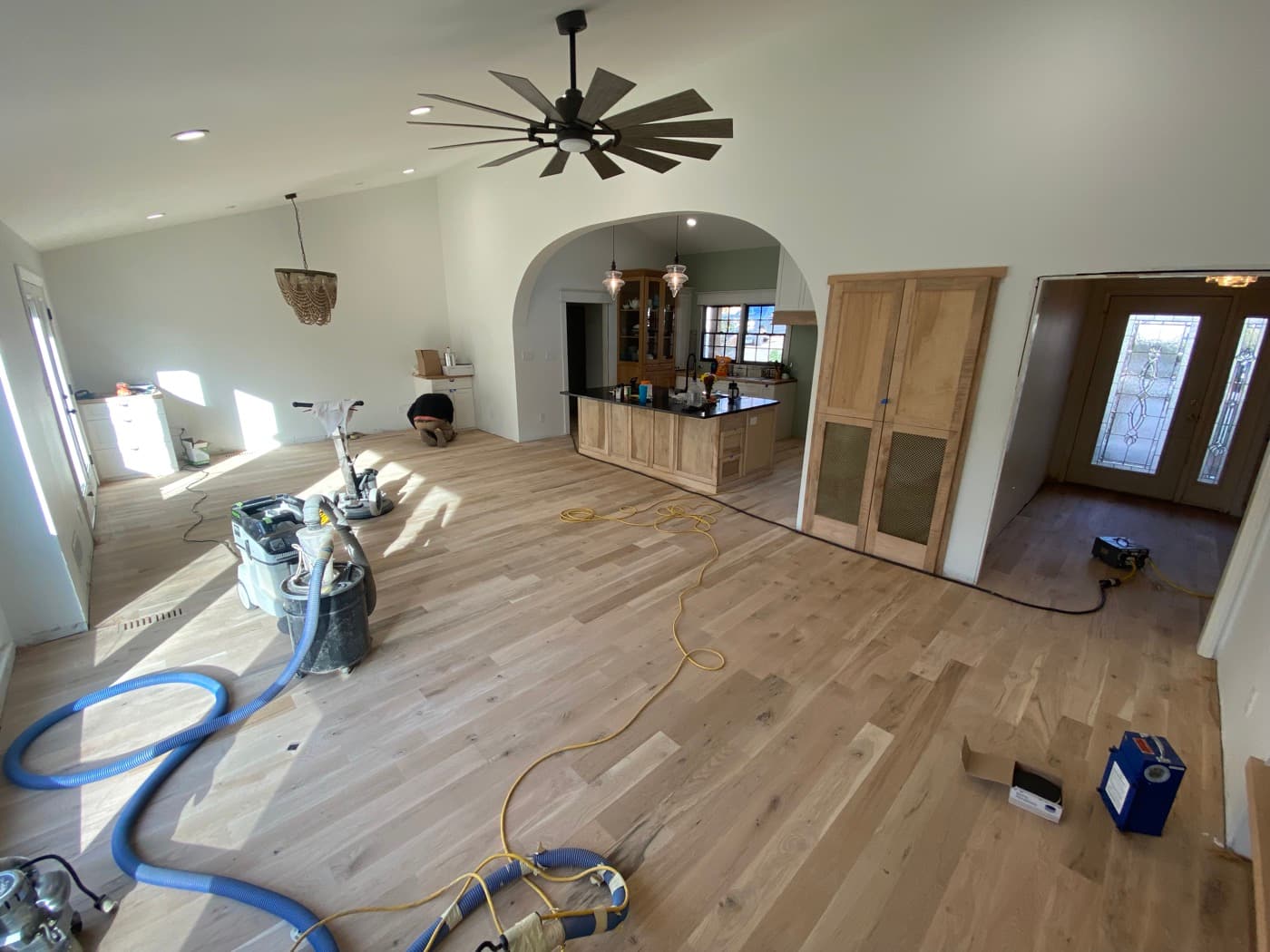 Bona PowerDrive sanding in progress across open plan living room and kitchen during Oak Park Raleigh NC white oak installation