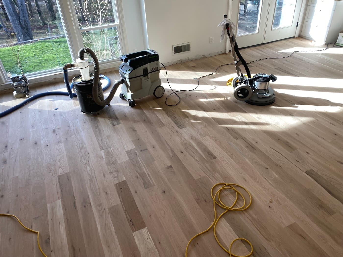 Festool buffer and HEPA vacuum during final surface prep before Pallmann Magic Oil application in sunroom Oak Park Raleigh NC