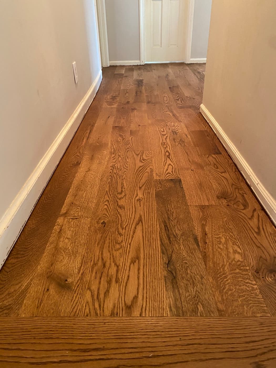 White oak accent wall finished with custom Pallmann Magic Oil blend matching the floor in Oak Park Raleigh NC