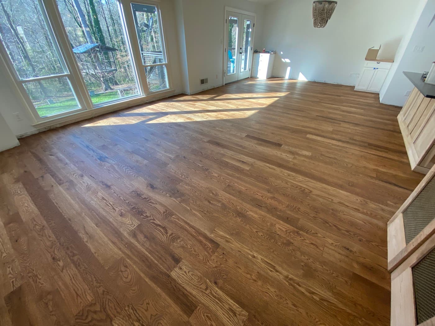 Finished 5-inch engineered white oak floors with custom Pallmann Magic Oil blend in Oak Park Raleigh NC, wide view with French doors