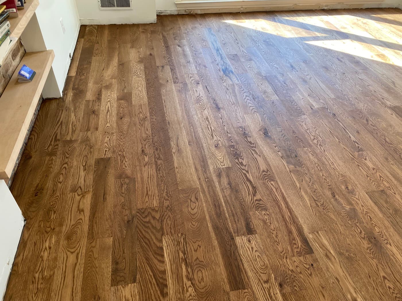Finished Pallmann Magic Oil white oak floor wide shot with built-in shelving in Oak Park Raleigh NC