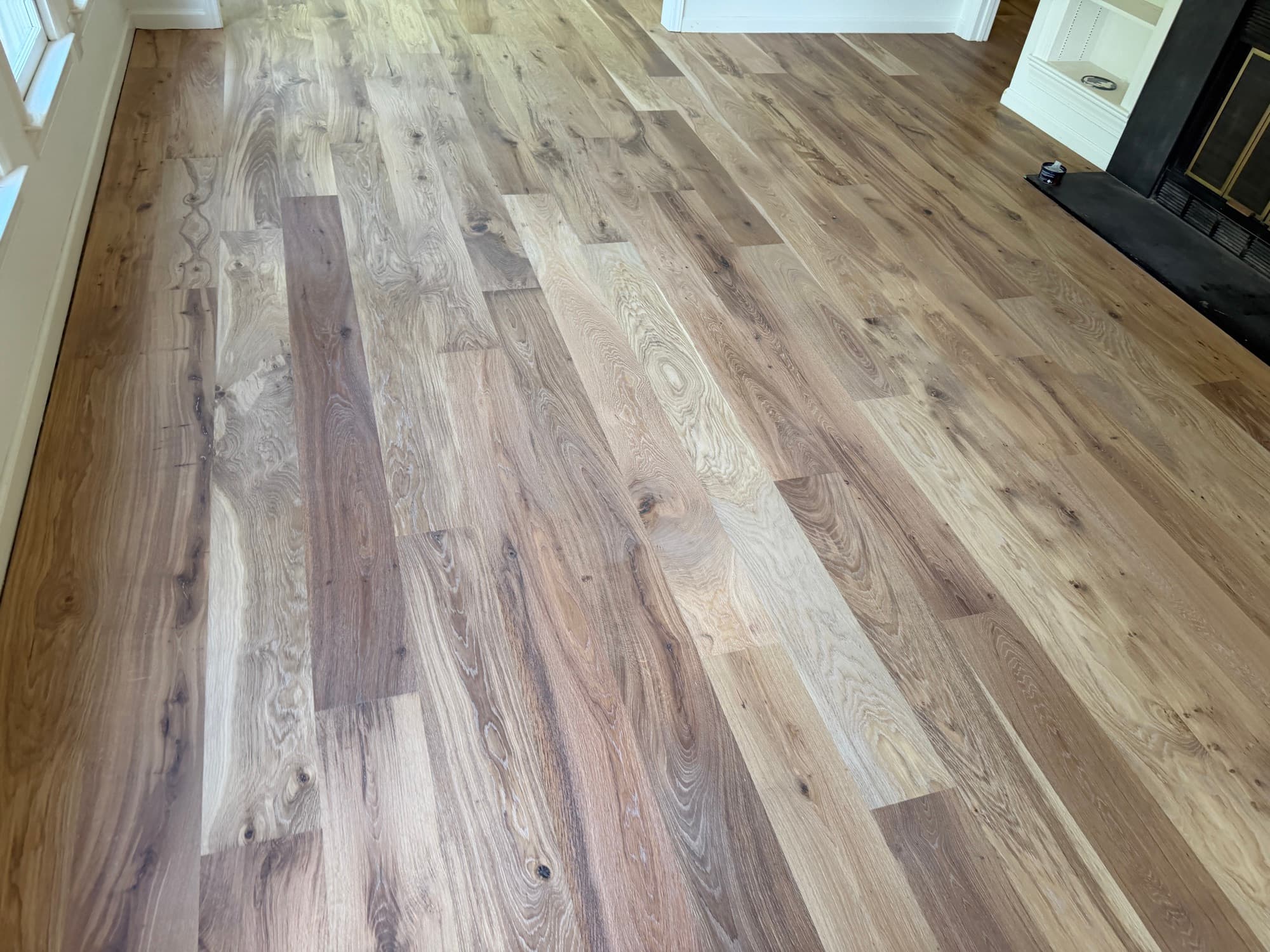 Natural color variation across wide plank European white oak in Raleigh living room
