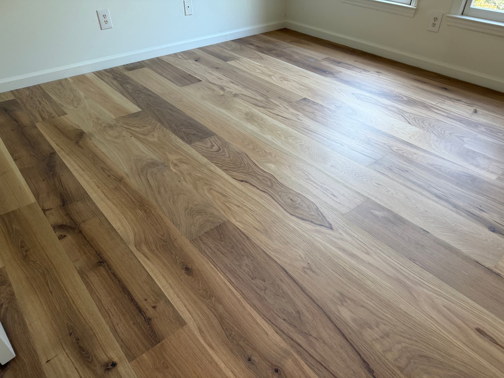 Bedroom with finished European white oak floor in natural light, Downtown Raleigh