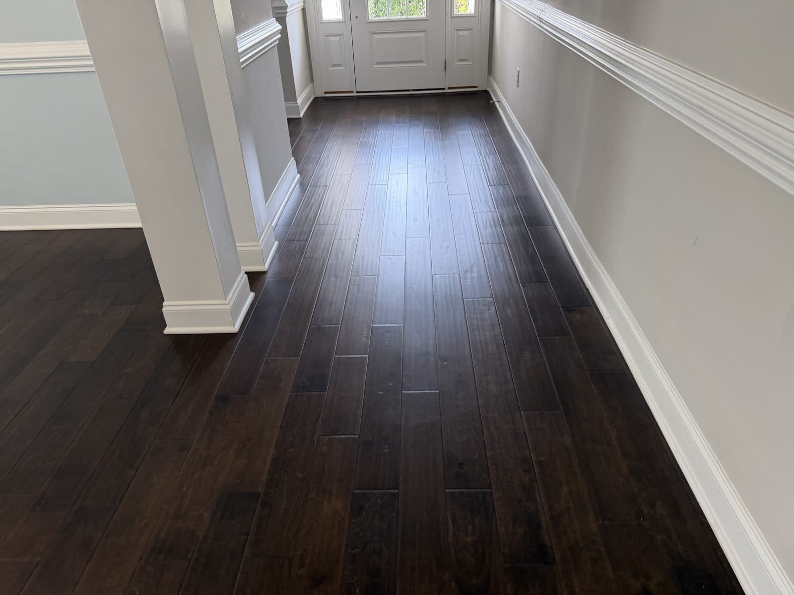 Foyer and hallway to the front door after polish removal and deep clean in Fuquay-Varina NC