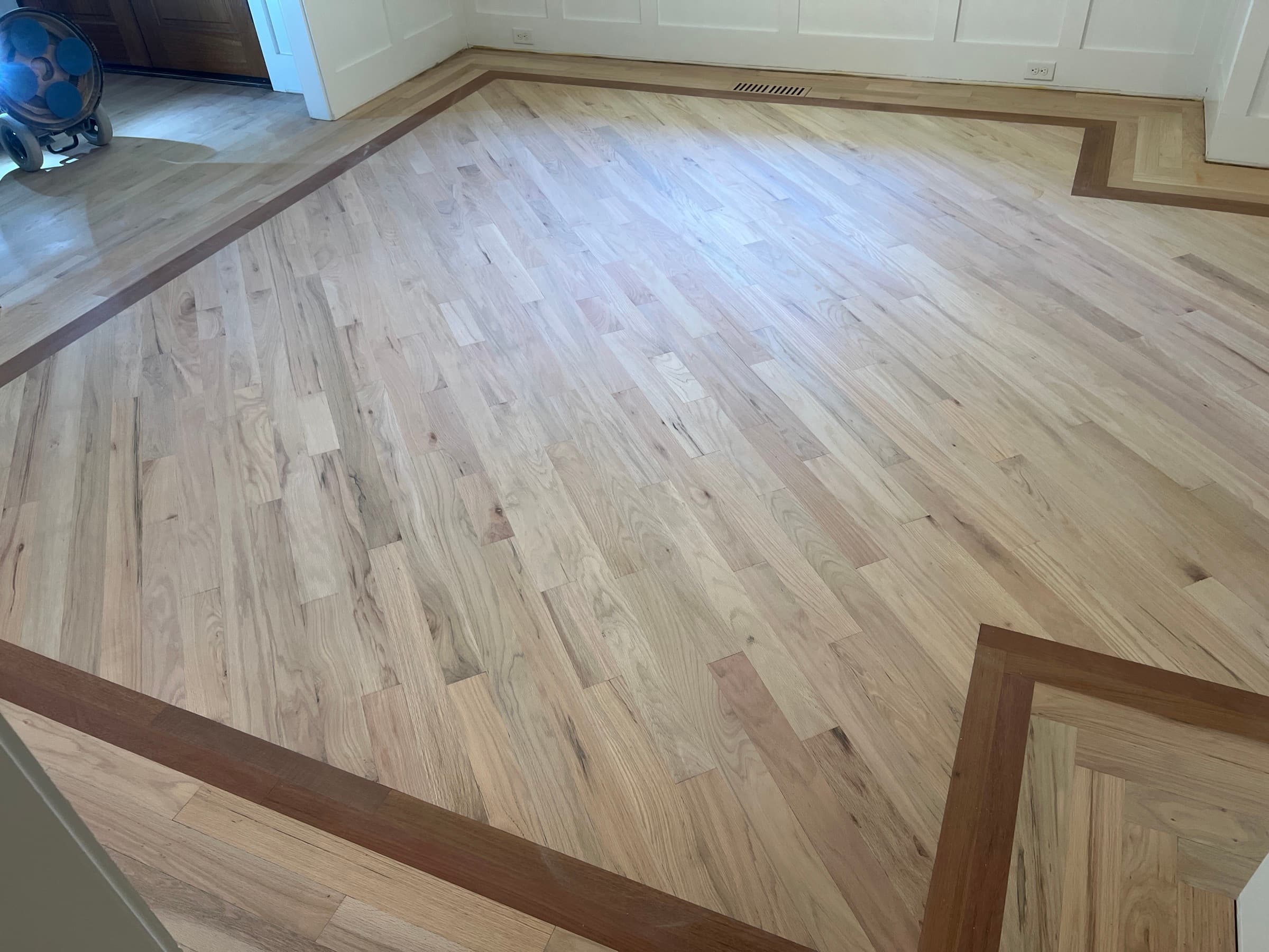 Red oak floors sanded bare with Brazilian Cherry border visible in Flowers Plantation Clayton NC before stain