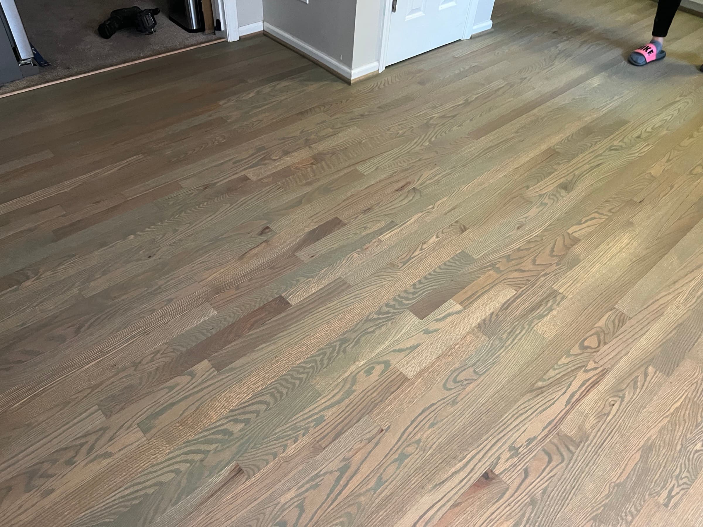 Finished custom olive brown hardwax oil red oak floor in Matthews Farm Clayton NC kitchen looking toward doorway