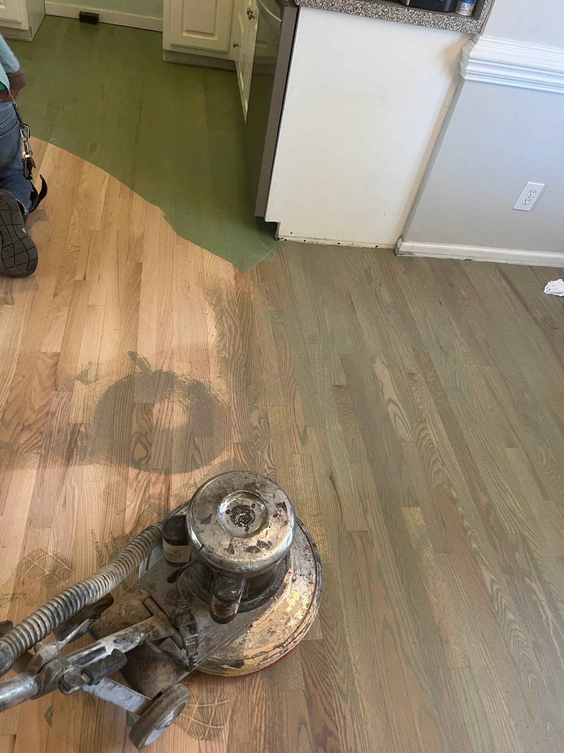 Buffer sanding repaired and existing red oak floor as one surface in Matthews Farm Clayton NC kitchen before finish