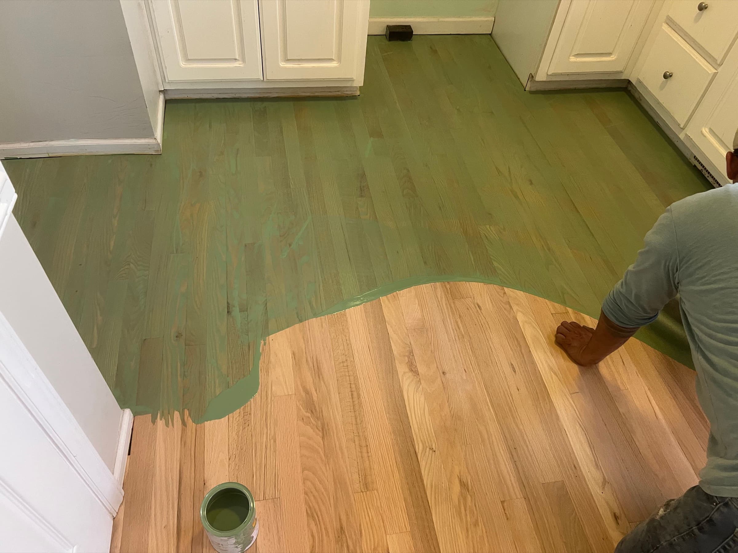 Custom olive brown hardwax oil blend being applied to red oak kitchen floor in Matthews Farm Clayton NC, wet finish line visible