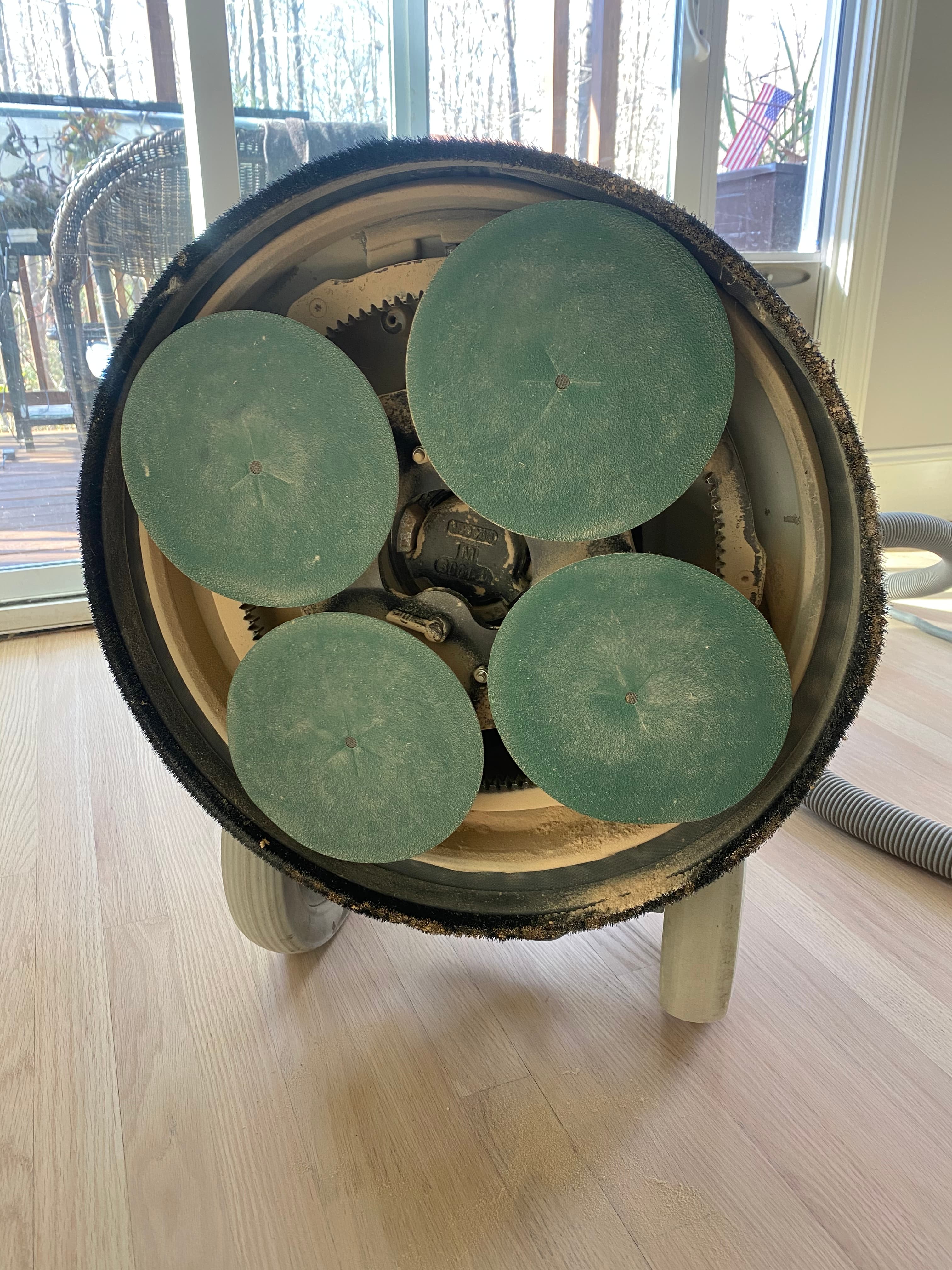 Bona PowerDrive planetary sander four rotating heads viewed from below during hardwood refinishing in Hocutt Farm Clayton NC