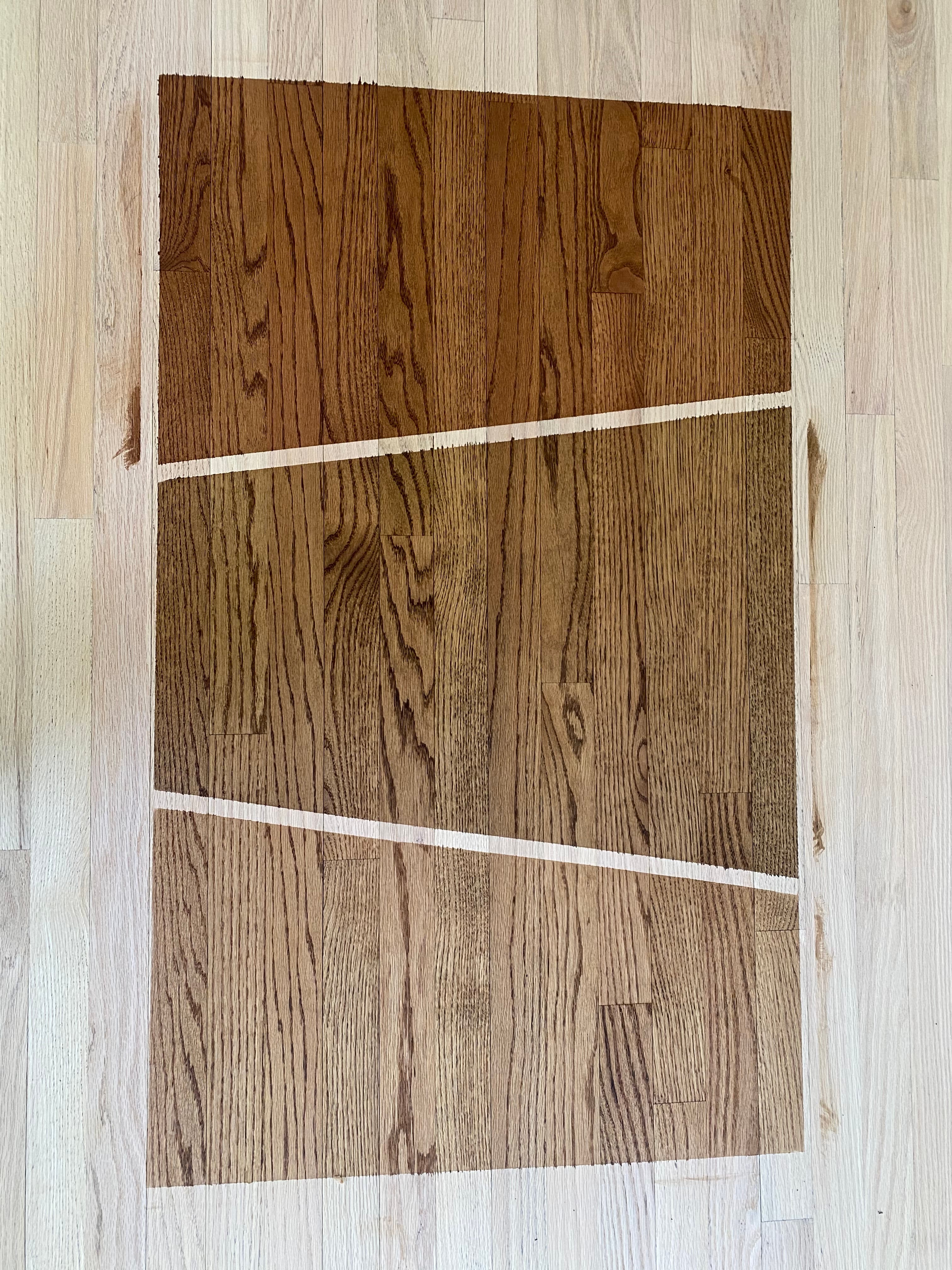 Three DuraSeal custom blend stain samples side by side on sanded red oak floor in Hocutt Farm Clayton NC, comparing tones before committing