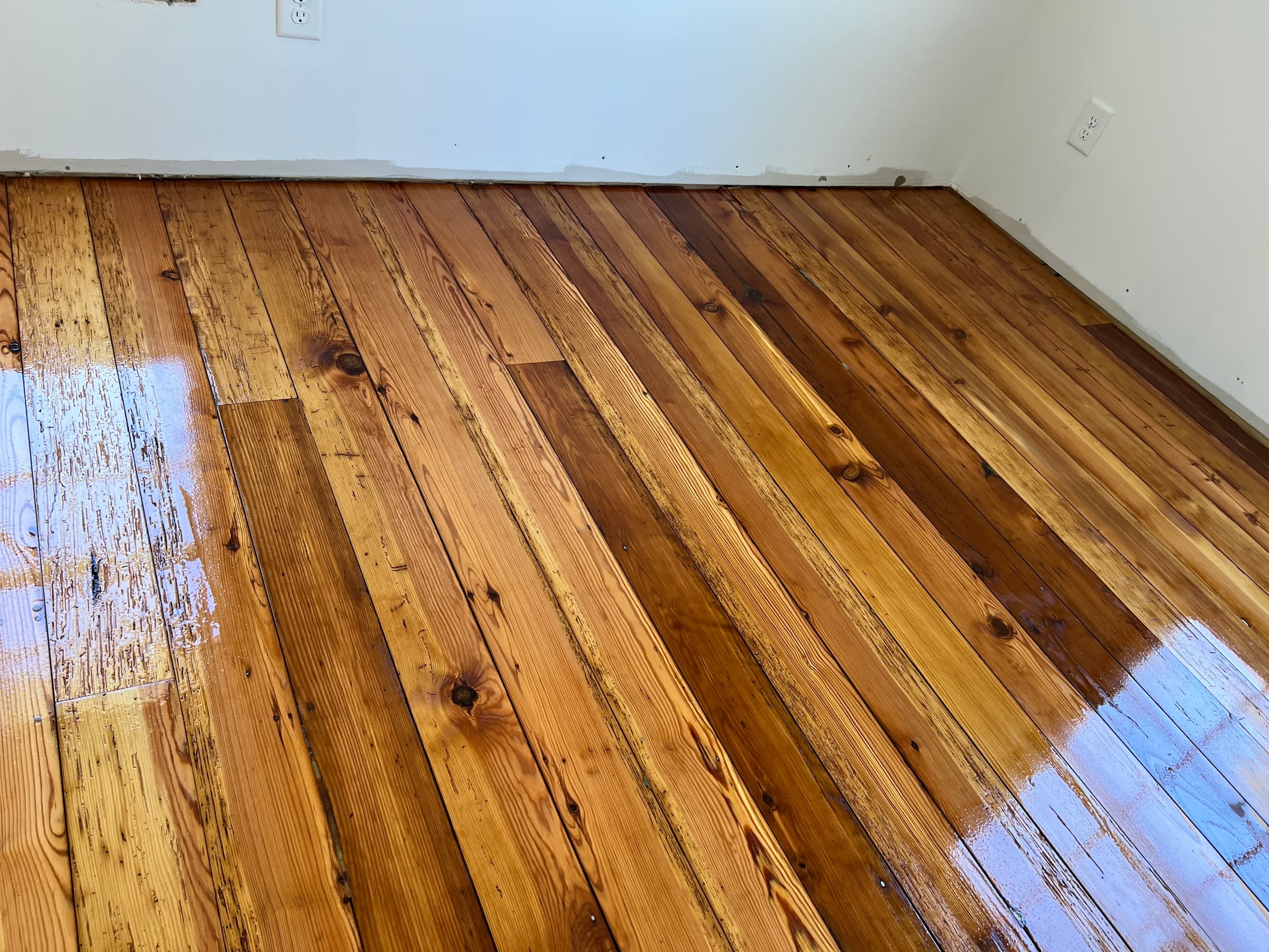 Finished historic heart pine hardwood floors in Morrisville NC after refinishing with tinted water-based finish, warm honey tones