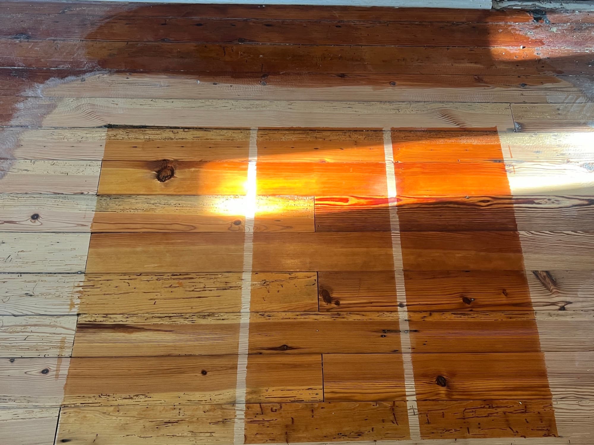 Tinted finish test panels on sanded heart pine during refinishing in Morrisville NC, comparing stain options side by side
