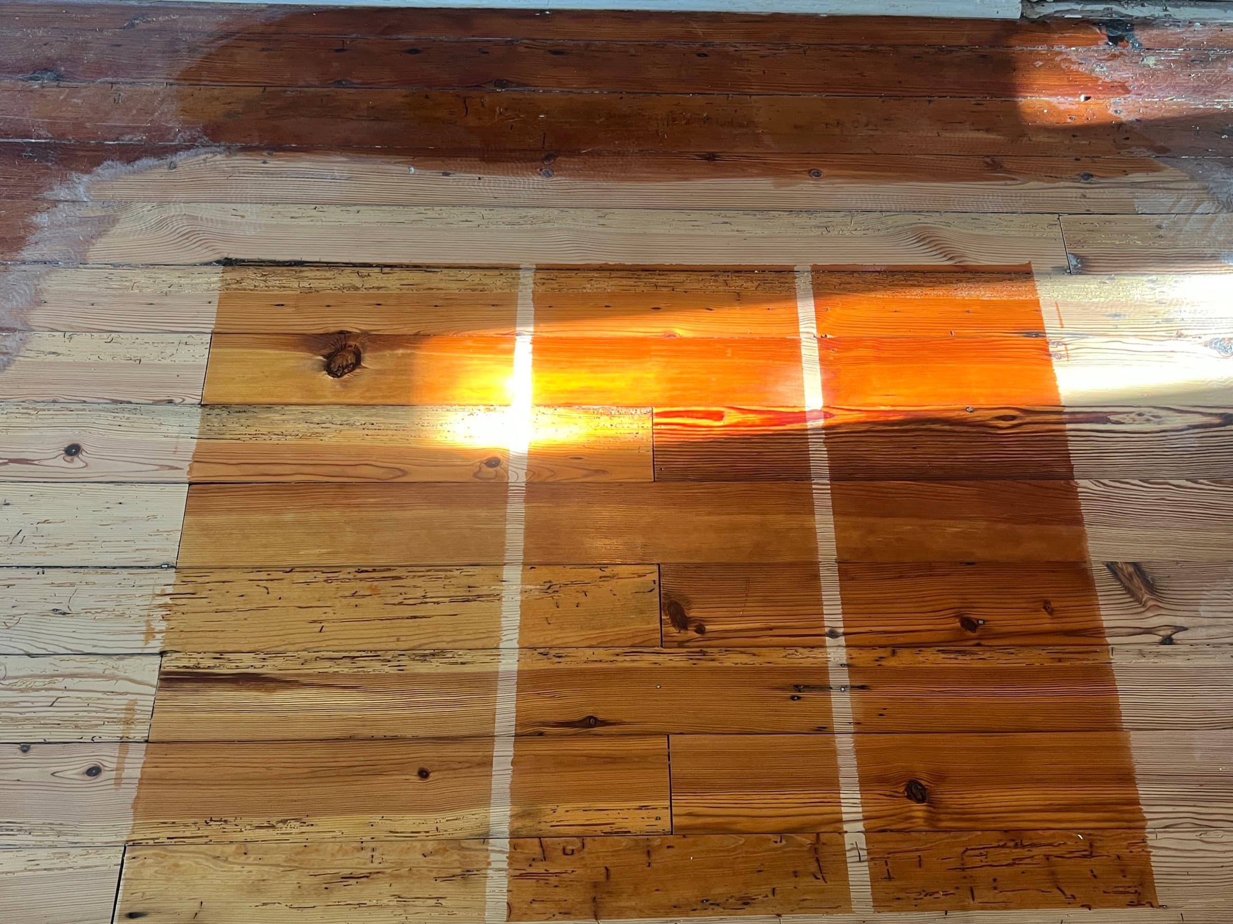 Tinted finish test panels on sanded heart pine during refinishing in Morrisville NC, comparing stain options side by side