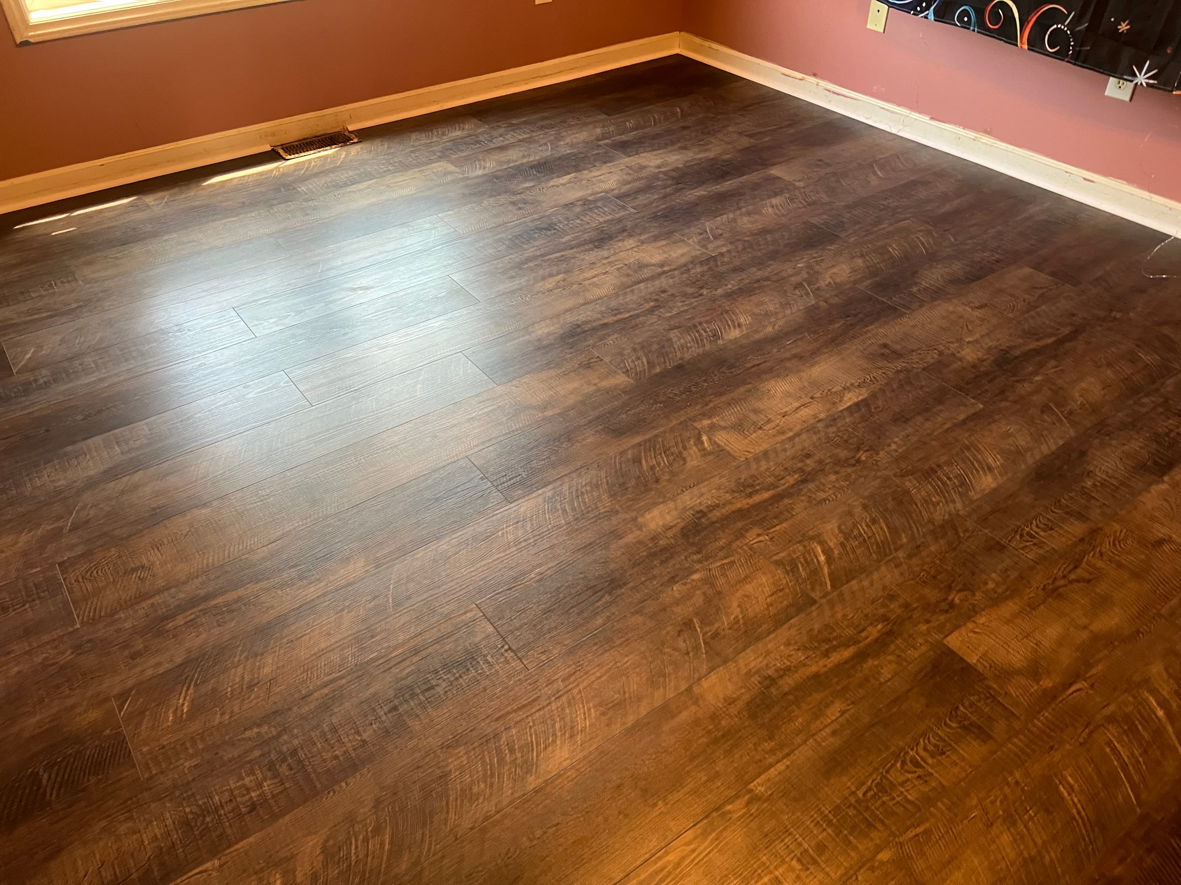 Finished Choice Flooring SPC LVP in secondary bedroom in Buffalo Creek Zebulon NC, warm Wine Barrel color with quarter round