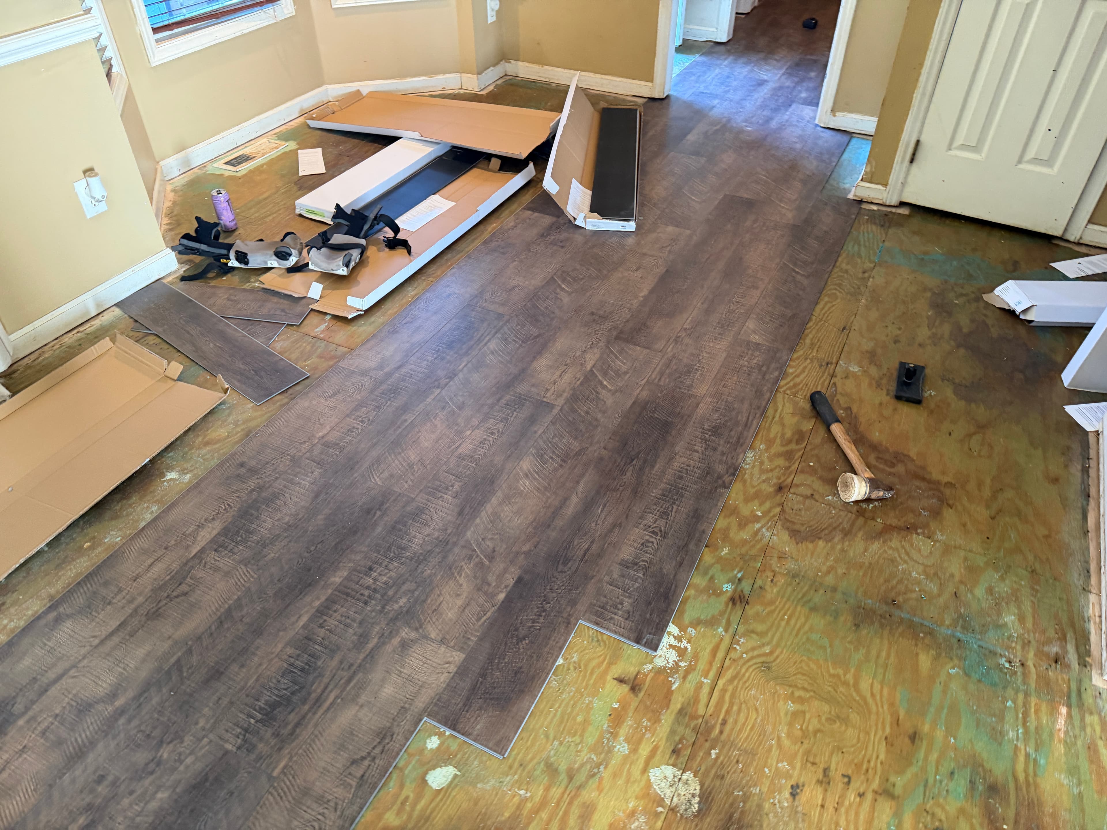LVP flooring installation in progress through hallway and rooms in Buffalo Creek Zebulon NC