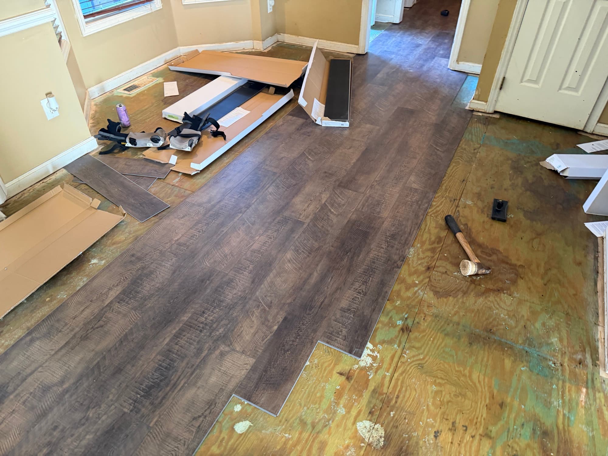 LVP flooring installation in progress through hallway and rooms in Buffalo Creek Zebulon NC