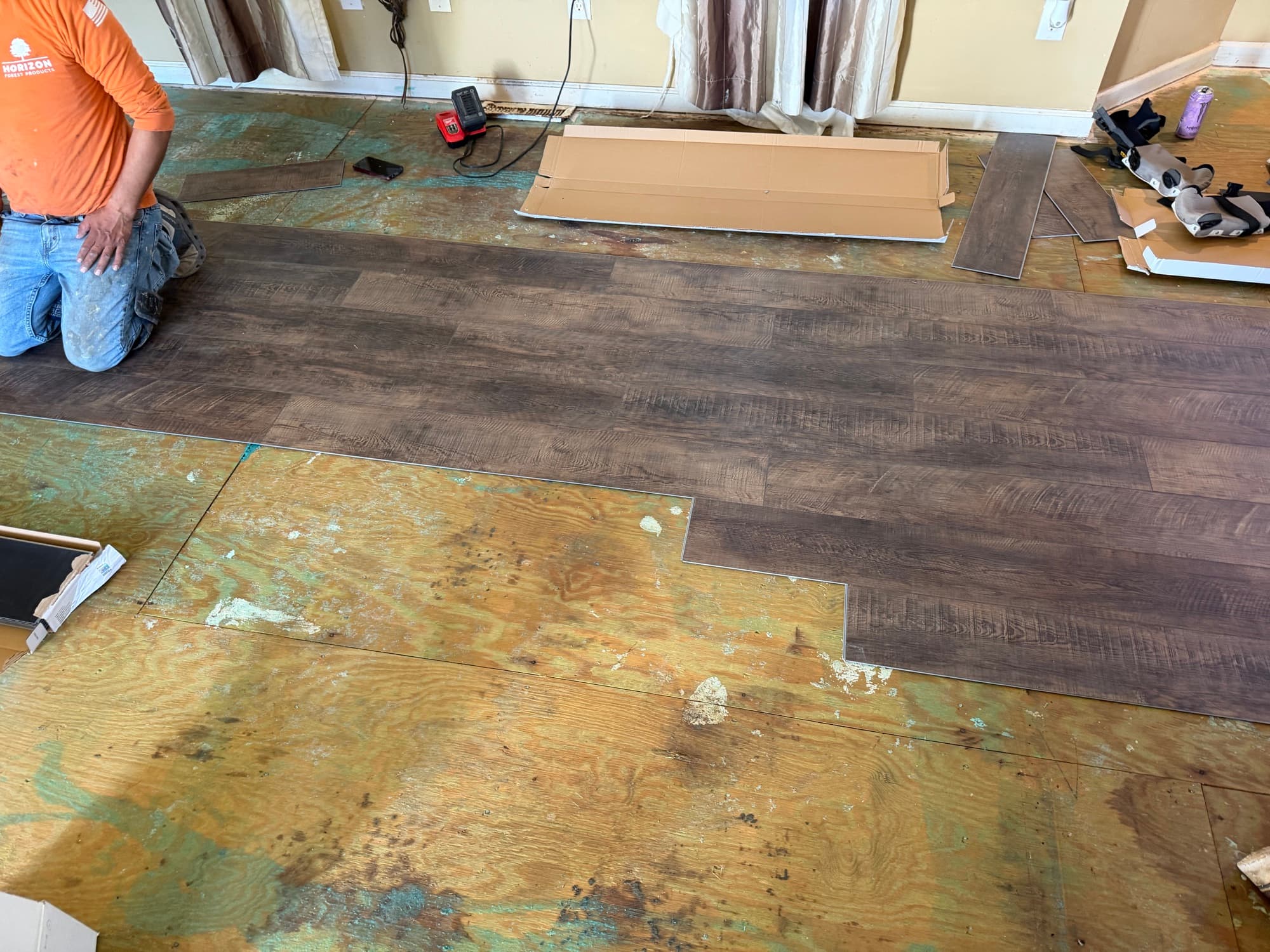SPC LVP installation progress in bedroom area in Buffalo Creek Zebulon NC home, subfloor and installation visible