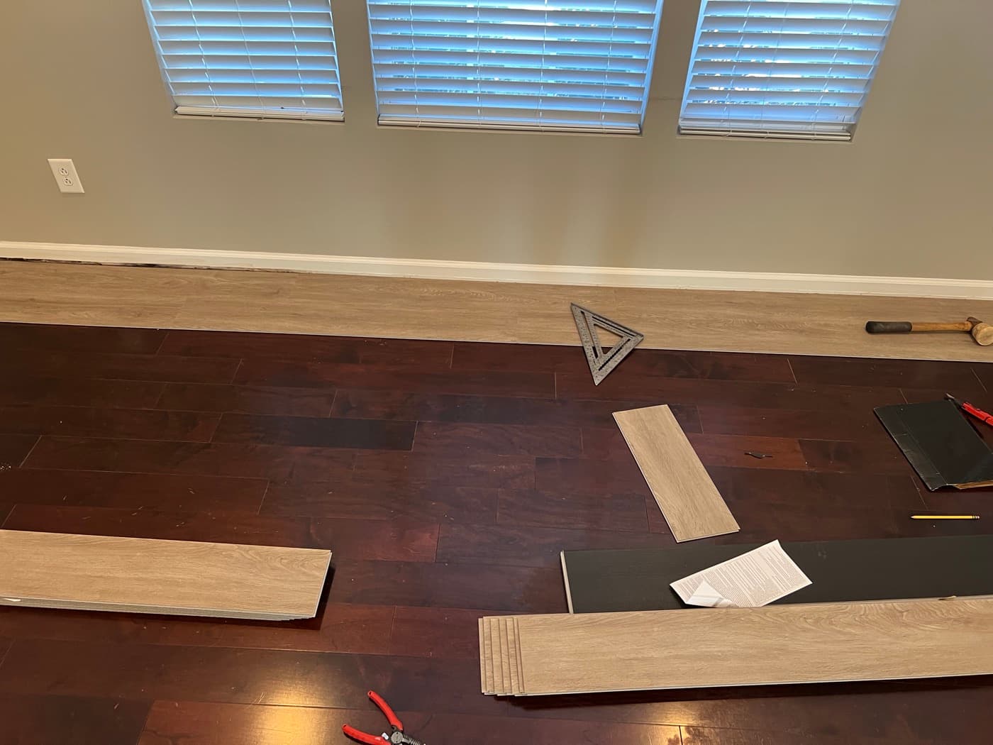 Worn dark engineered hardwood flooring in Miriah Towns townhouse before LVP installation, Garner NC
