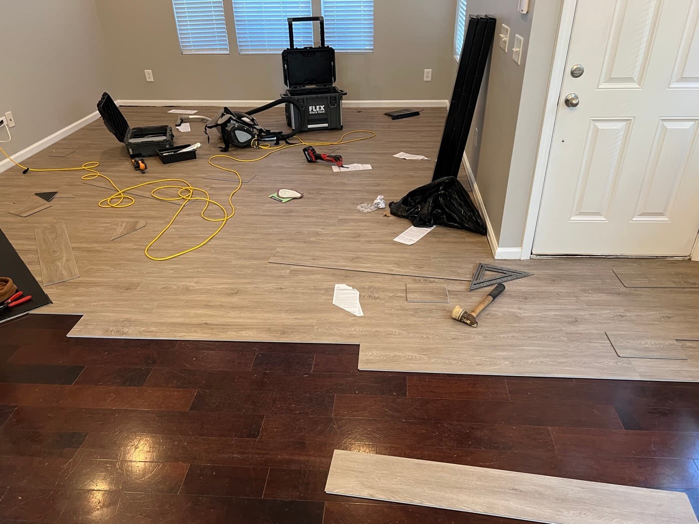LVP installation nearly complete in Miriah Towns townhouse living room, tools and materials visible, Garner NC