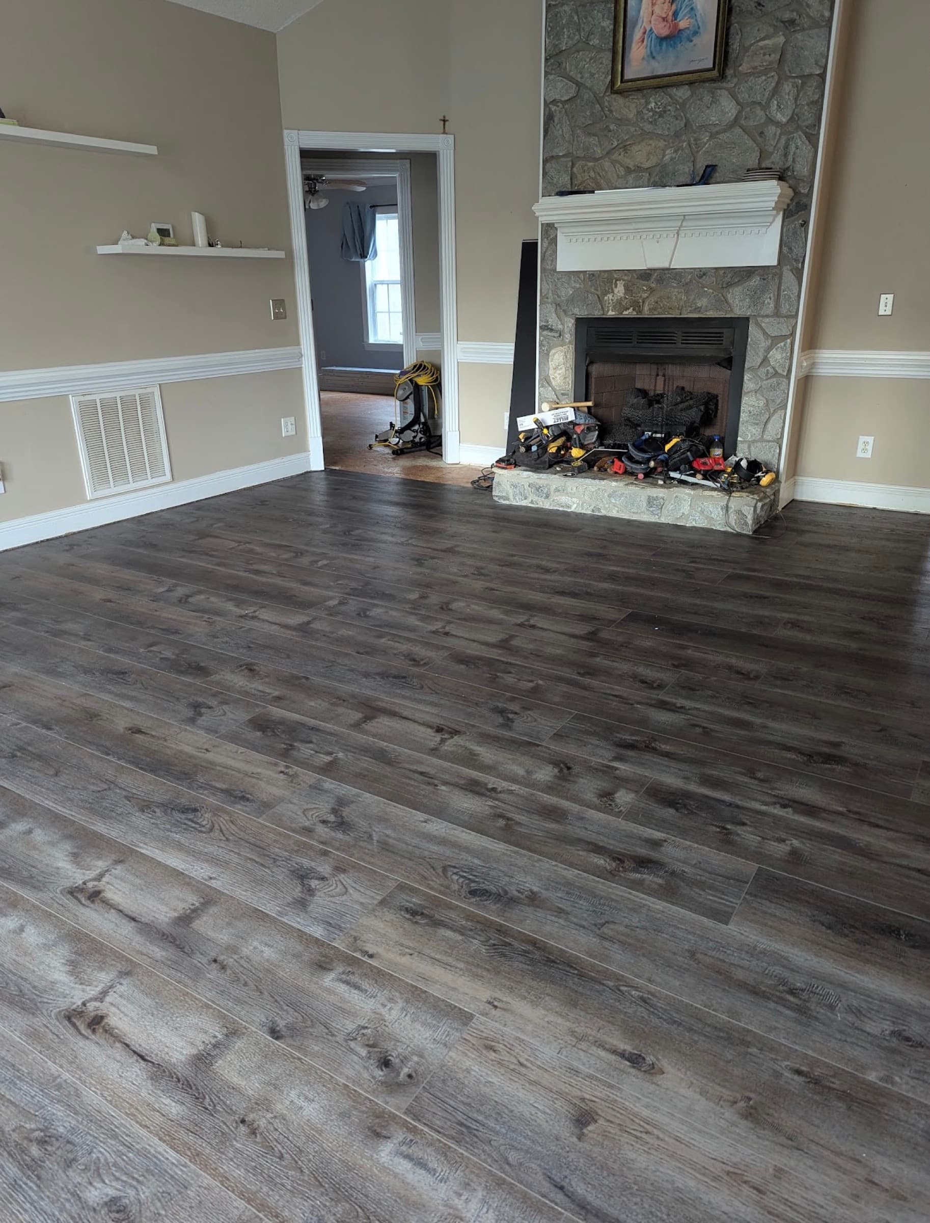 Finished Innova SPC Pearl River in living room with stone fireplace in Winston Plantation Clayton NC
