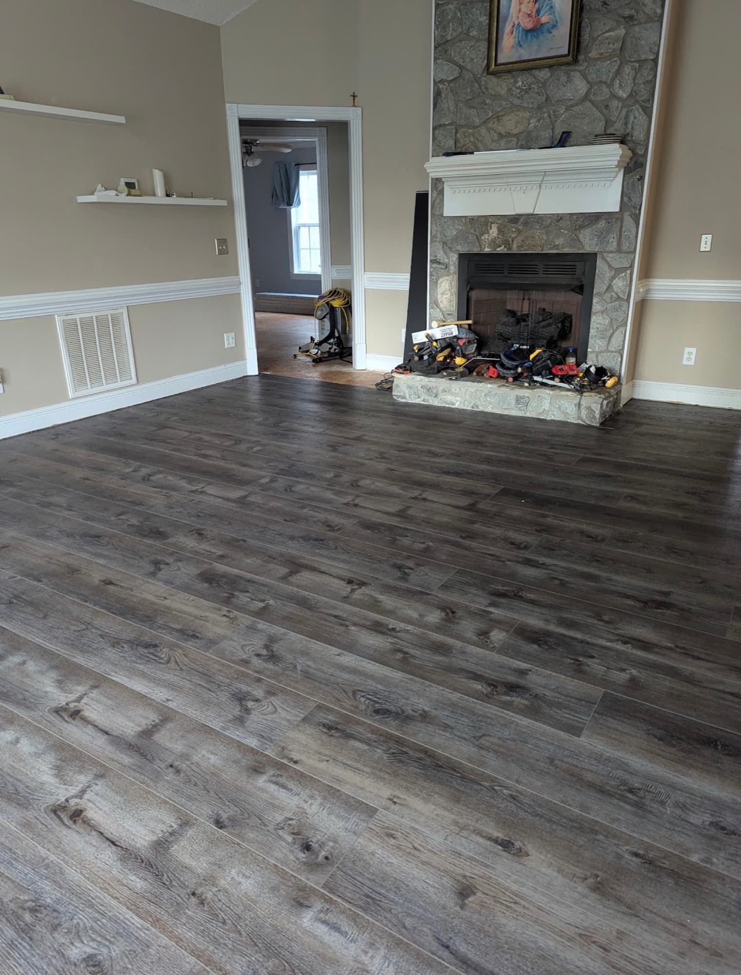 Finished Innova SPC Pearl River in living room with stone fireplace in Winston Plantation Clayton NC