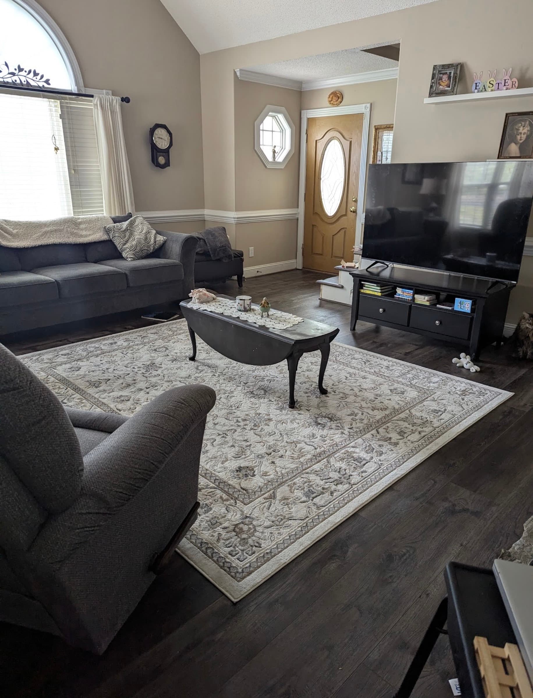 Finished Innova SPC Pearl River in furnished living room in Winston Plantation Clayton NC, dark wood tone with area rug