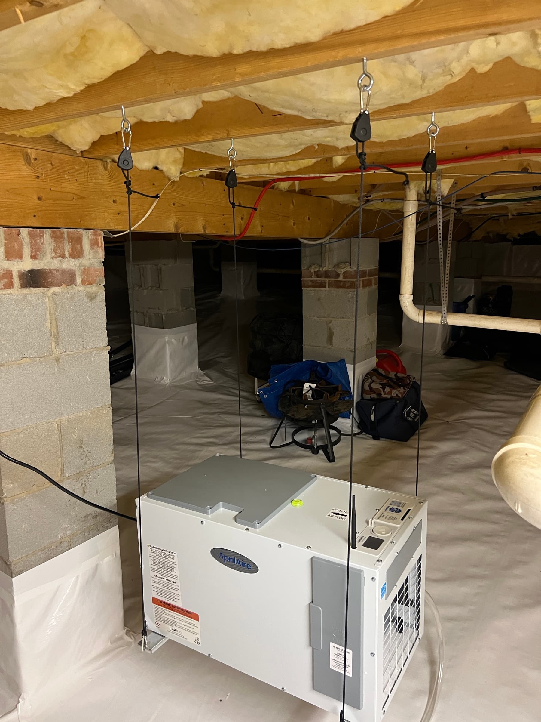 Crawl space encapsulation with vapor barrier and AprilAire dehumidifier installed in Zebulon NC home