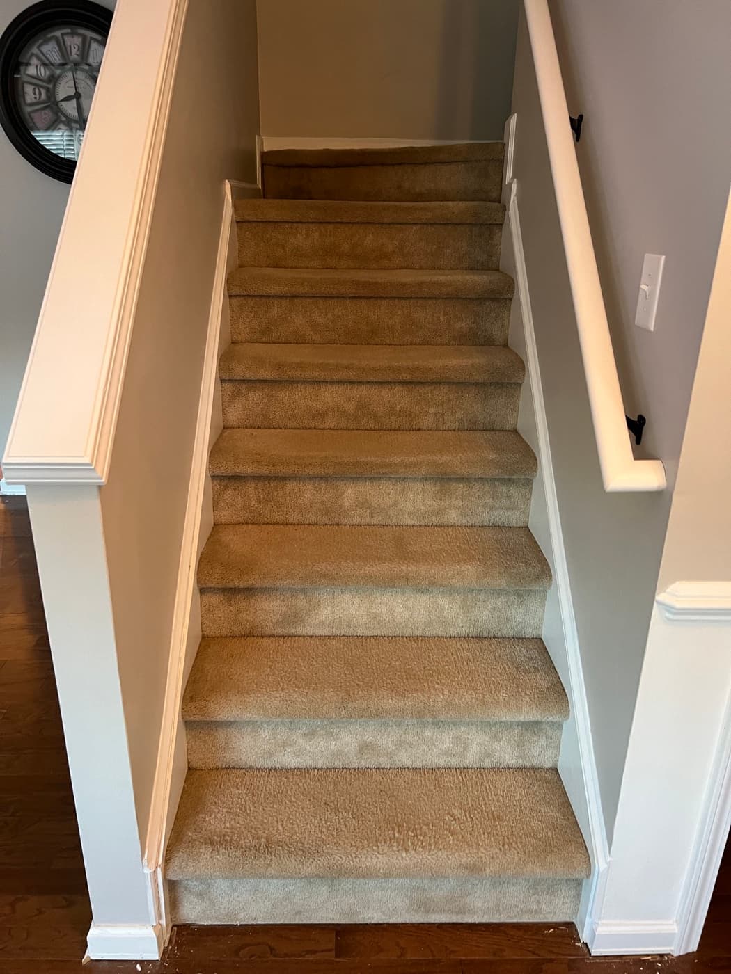 Top-down view of full carpeted staircase from above before LVP remodel in Tuscany Clayton NC